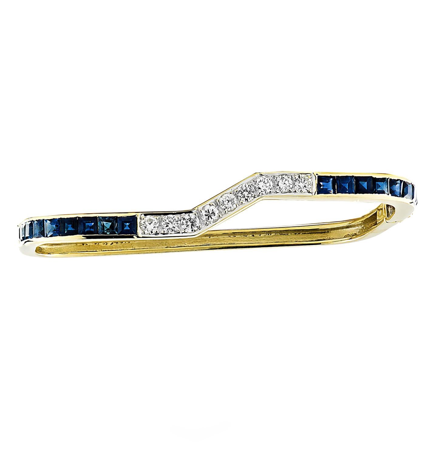 Stunning bangle set featuring two bangles crafted in 18 karat yellow gold and fashioned in a spectacular geometrical design. One bracelet is adorned with 9 round brilliant cut diamonds weighing approximately 1 carat total, G-J color, SI-I1 clarity