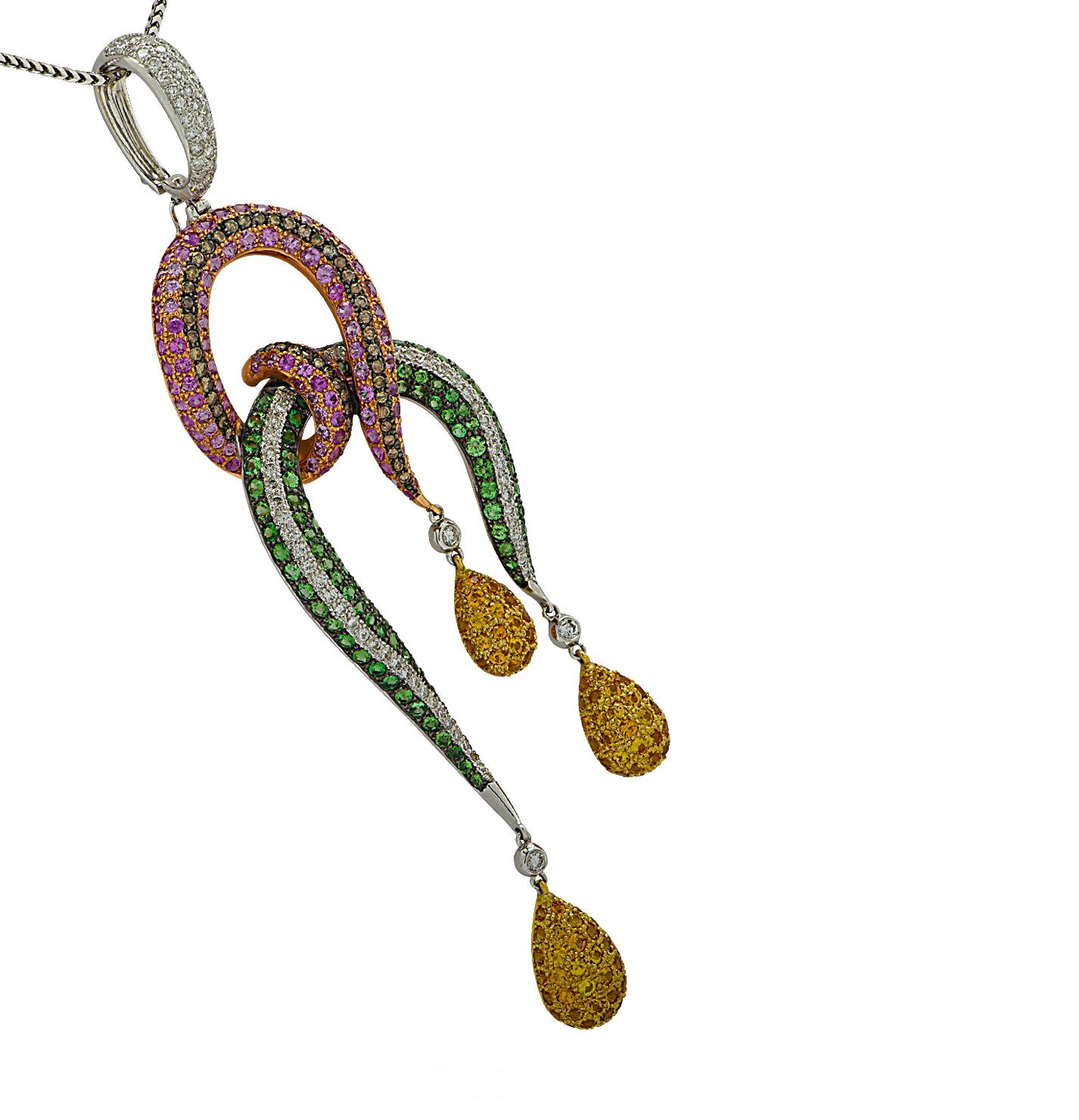 Striking necklace and pendant crafted in white gold featuring 2.46 carats of round brilliant cut diamonds, G color, VS-SI clarity, and brown diamonds, Pink and Yellow Sapphires weighing approximately 8.77 carats total and Emeralds weighing