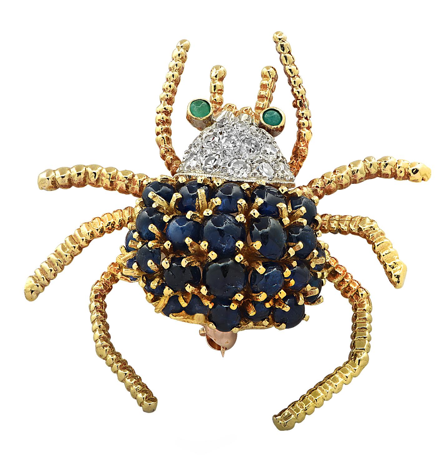 Enchanting spider brooch pin crafted in 18 karat yellow and white gold, adorned with 25 blue oval sapphire cabochons weighing approximately 2.50 carats total, 16 single cut diamonds weighing approximately .20 carats total, G color, VS clarity and 2