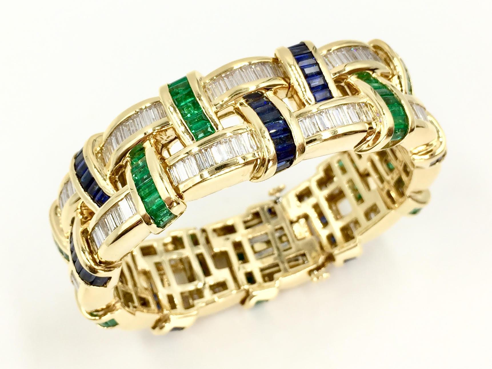 Hand made with exceptional quality by master jeweler Charles Krypell. This unique wide bracelet with a basket weave design featuring 12.30 carats of white baguette diamonds. 8.20 carats of rich blue sapphires and 5.80 carats of lively green