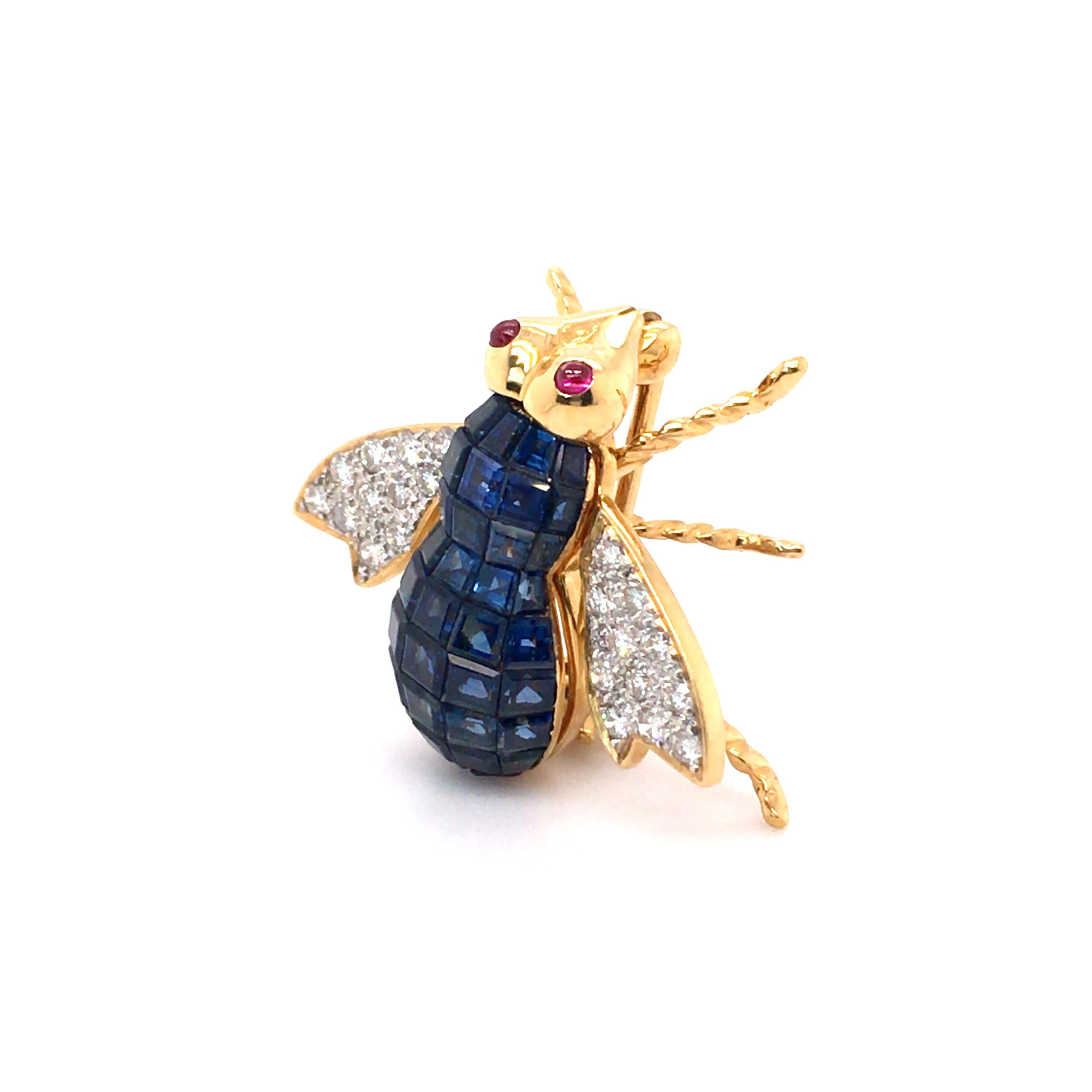 This charming insect brooch from the Haruni Vaults is handmade in 18k yellow gold with deep blue sapphires forming the body, pave-set sparkling diamonds in the wings, and round ruby cabochon eyes.

