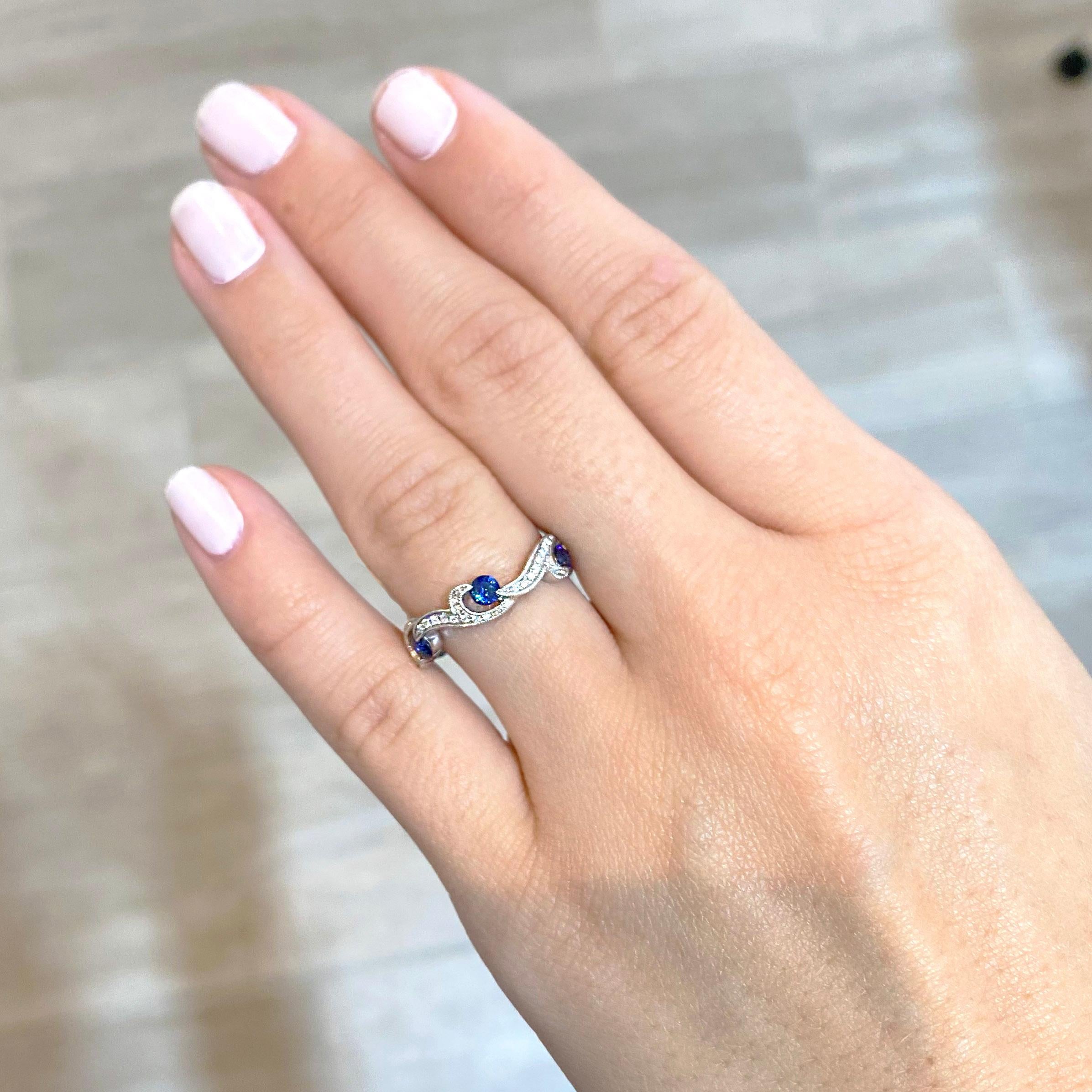This swirl sapphire and diamond ring in bright 14 karat white gold is beautiful! The genuine, natural gemstones go 3/4 the way around eternity. This ring can be ordered in any ring size and in 14k yellow or rose gold.
The details for this beautiful
