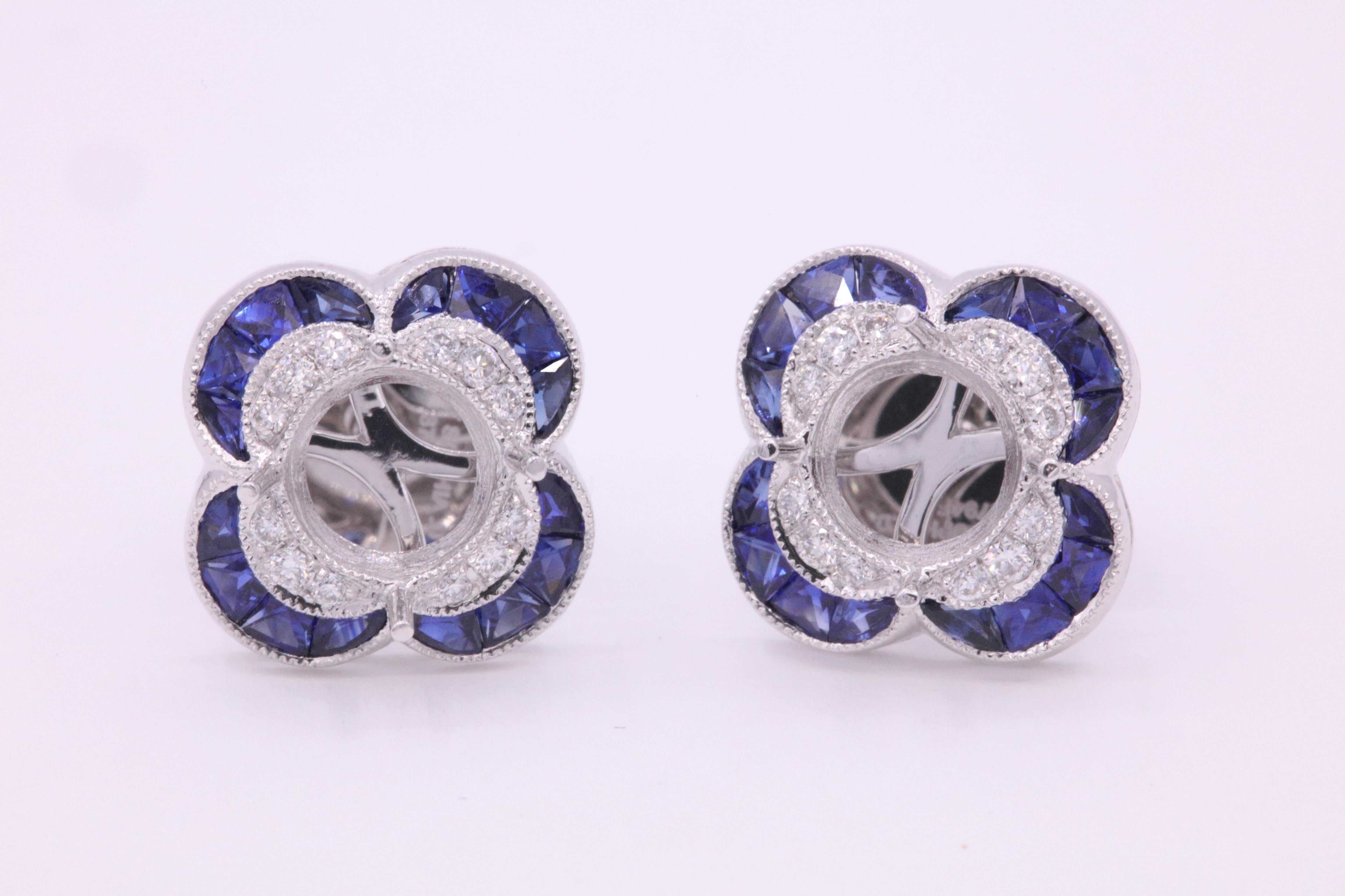 Gorgeous Art Deco style bezel earrings featuring vibrant blue sapphires weighing 1.05 carats and round brilliants weighing 0.14 carats crafted in platinum.
Measures 3/8-1/4