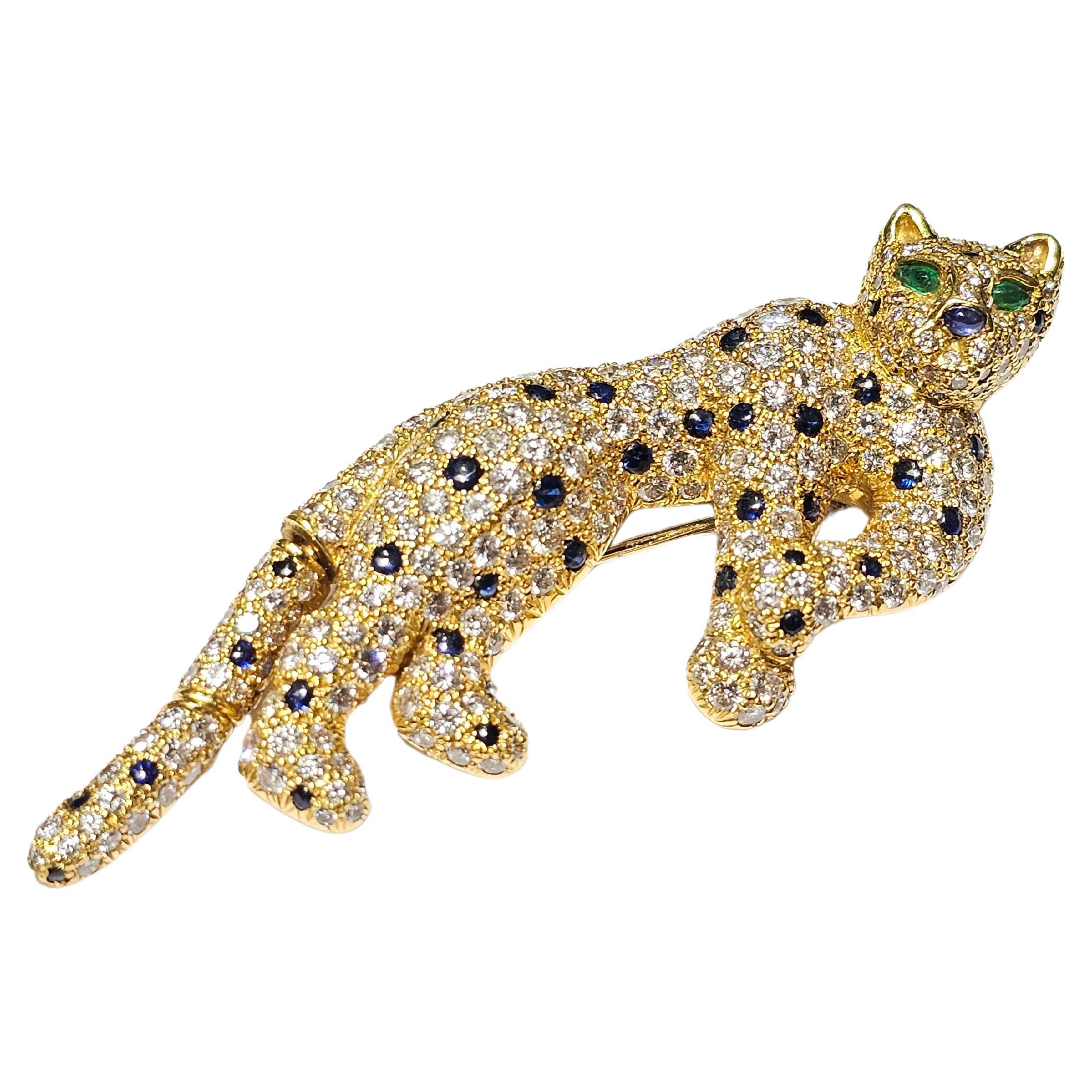 Diamond & Sapphire Cat Brooch

An 18-karat yellow gold cat motif brooch featuring an articulated tail. Set with round cut diamonds, cabochon sapphires, and cabochon emerald eyes.

Stamped 750

Measurements: 2.75