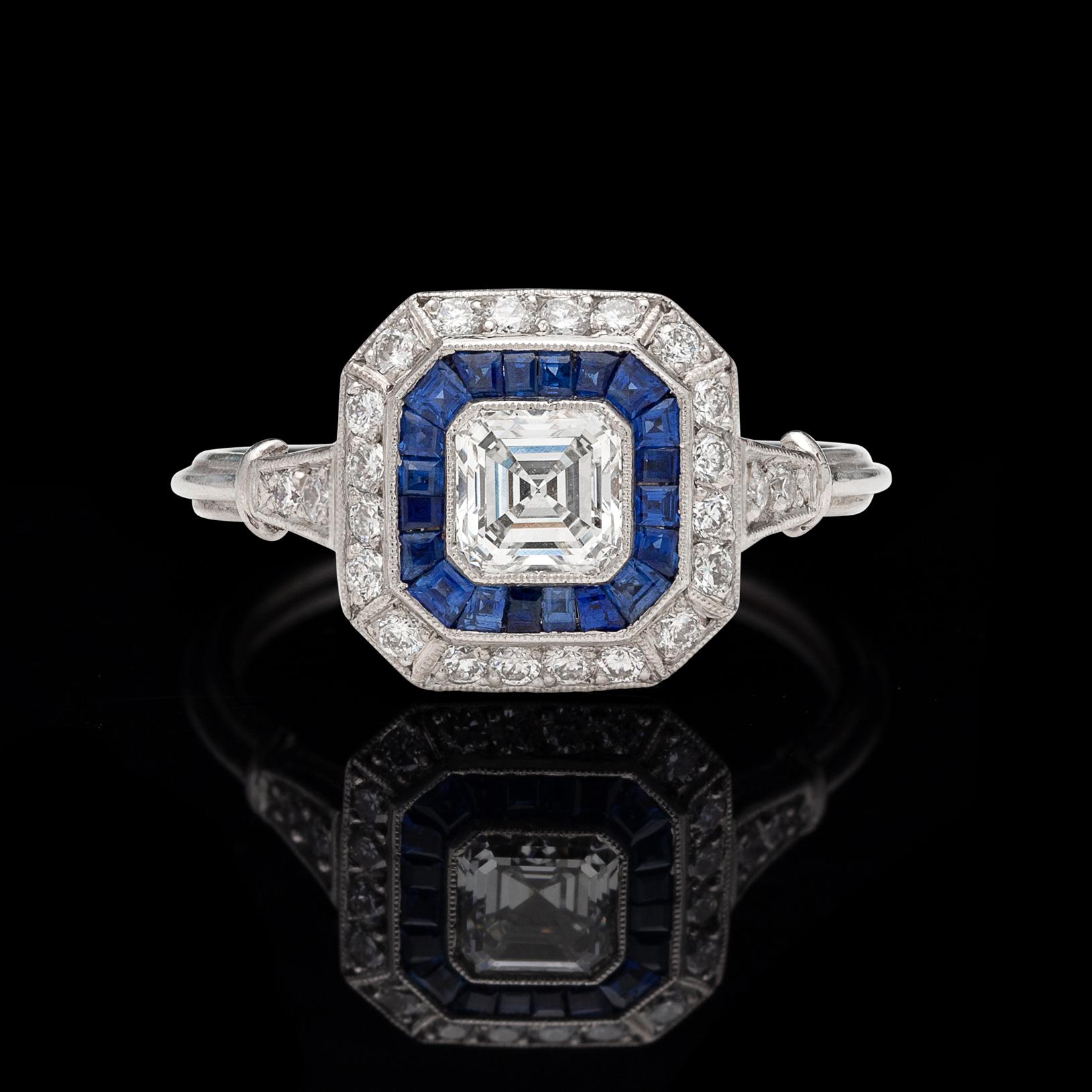 An Art Deco inspired 18k white gold ring for the ages! It centers around a gorgeous bezel-set Asscher-cut diamond, weighing an estimated 0.55 carat, G/VS, set within a frame of calibre-cut sapphires, and then a second frame of 24 round brilliant-cut