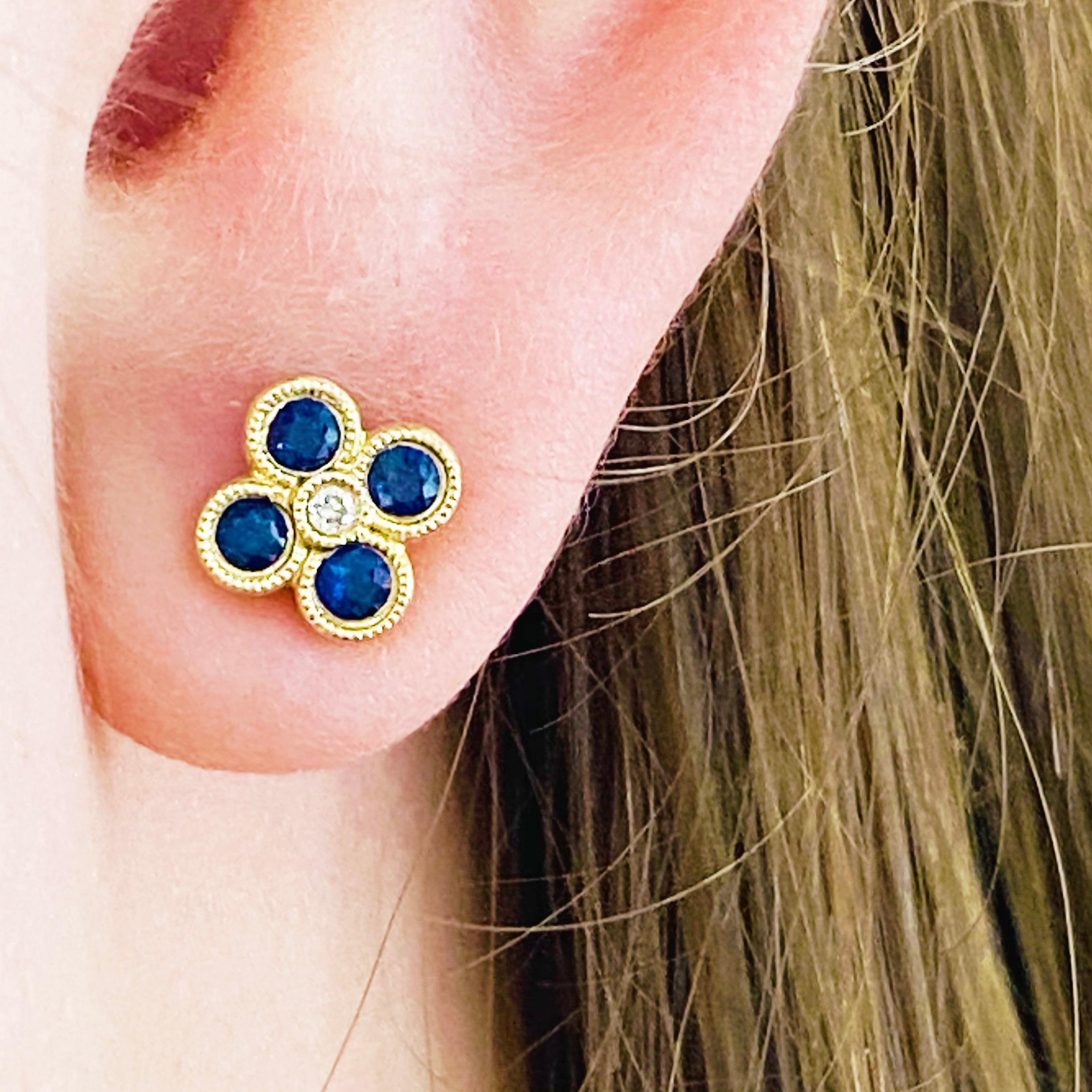 These stunning 14k yellow gold detailed deep blue sapphire studs dripping with diamonds provide a look that is both trendy and classic. These sapphire and diamond earrings are a great staple to add to your collection, and can be worn with both