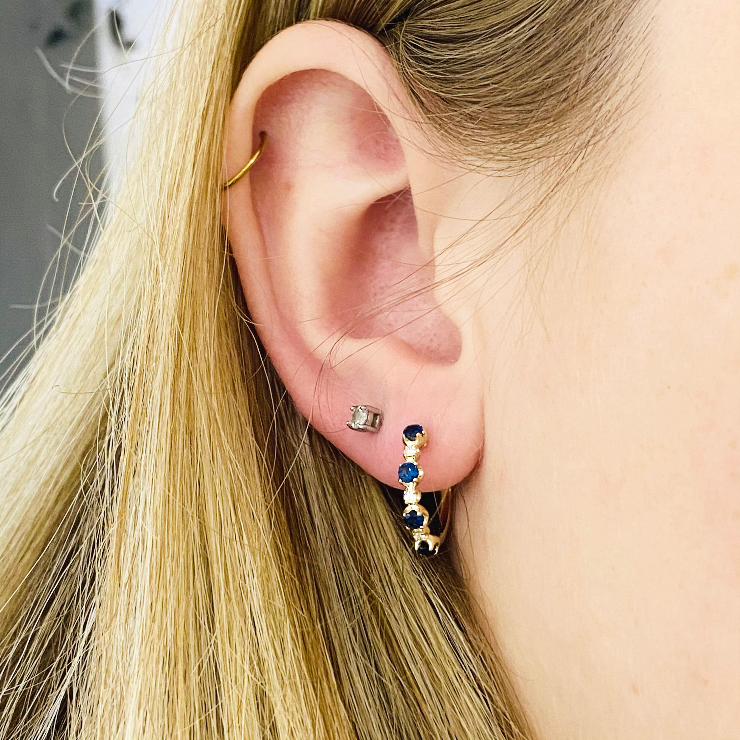 These stunning 14k yellow gold detailed deep blue sapphire huggie hoops dripping with diamonds provide a look that is both trendy and classic. These sapphire and diamond earrings are a great staple to add to your collection, and can be worn with