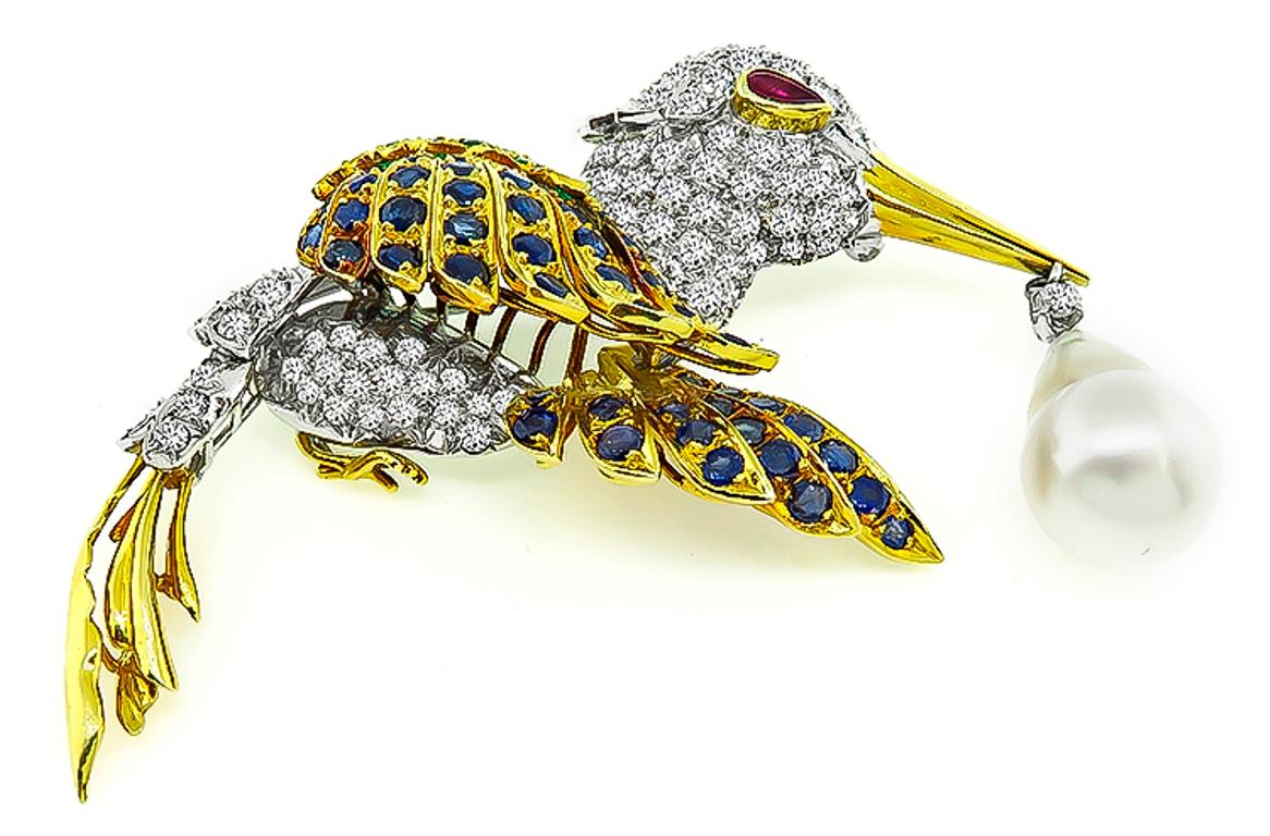 Made of amazing 18k and 14k gold, this stork pin is set with sparkling round cut diamonds that weigh approximately 6.50ct. graded F-G color with VS clarity. The diamonds are accentuated by lovely round cut sapphires and emeralds that weigh