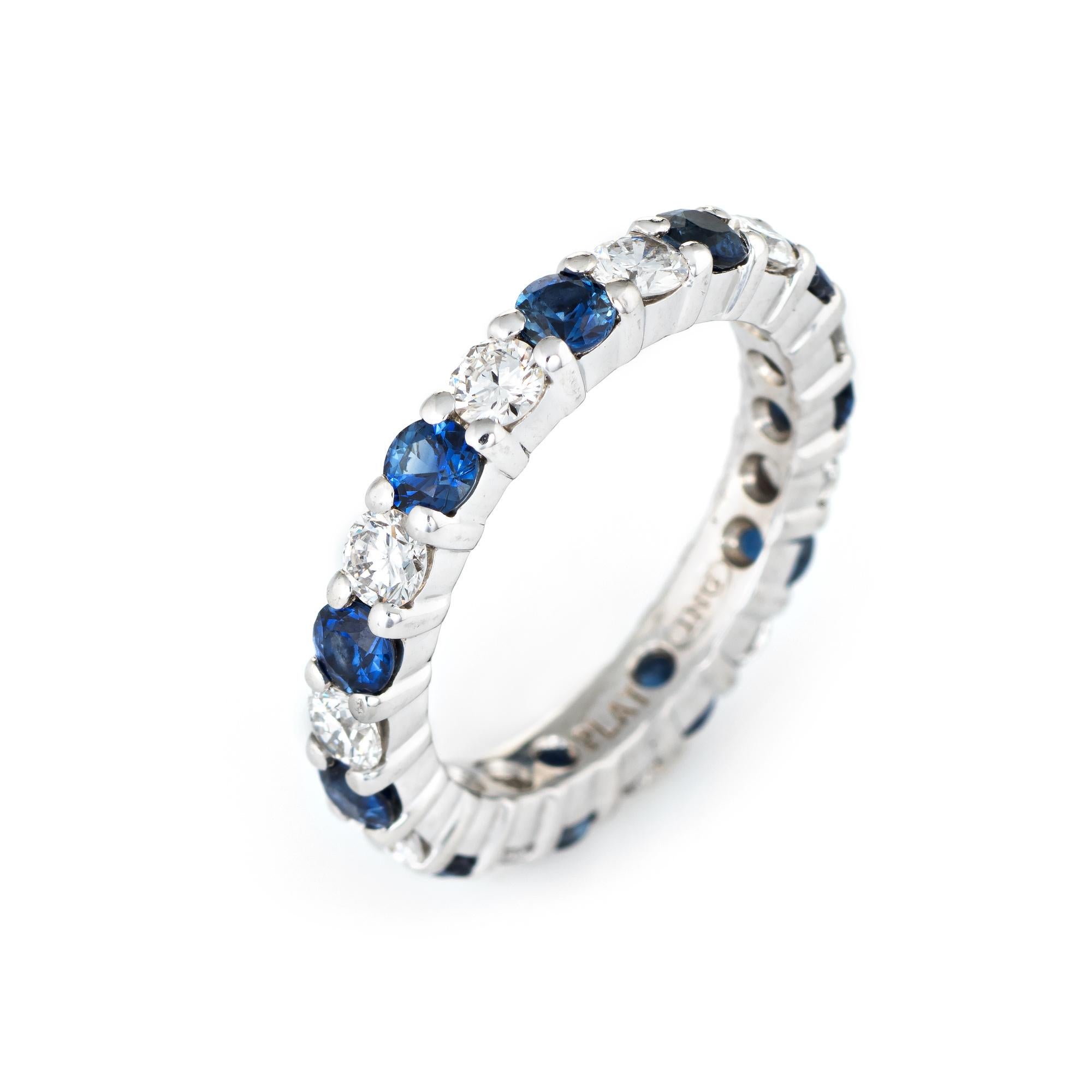 Stylish estate diamond & sapphire eternity ring crafted in 900 platinum. 

11 round brilliant cut diamonds are estimated at 0.10 carats each totaling an estimated 1.10 carats (estimated at H-I color and VS2-SI1 clarity). 11 blue sapphires are