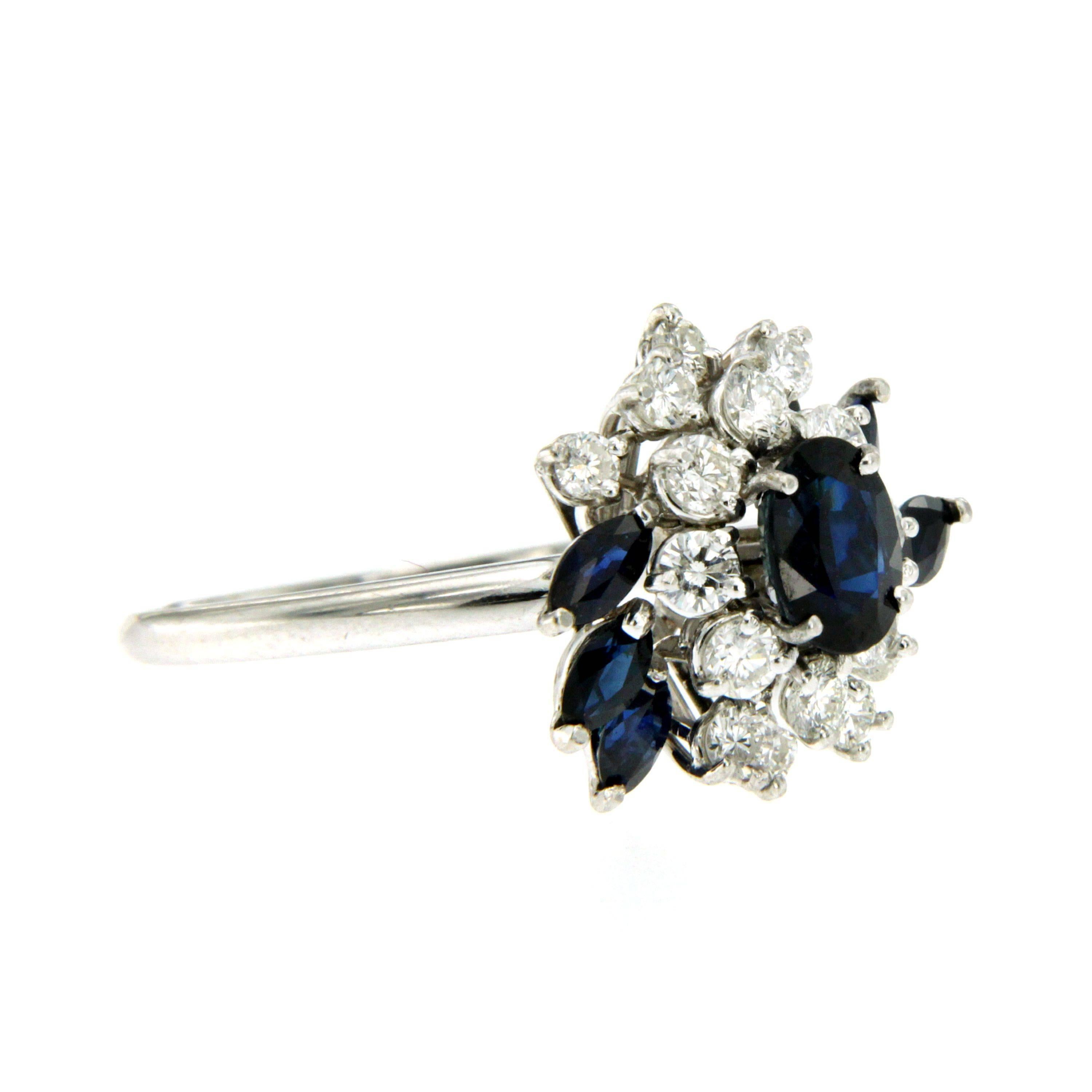 A beautiful made and timeless Sapphire Diamond cluster ring set in 18k white gold. 
The ring features a central Deep Blue Australian Oval cut Sapphire of 1.20 carat, surrounded by 0,70 carat of round Brilliant cut Diamond graded colorless Vvs