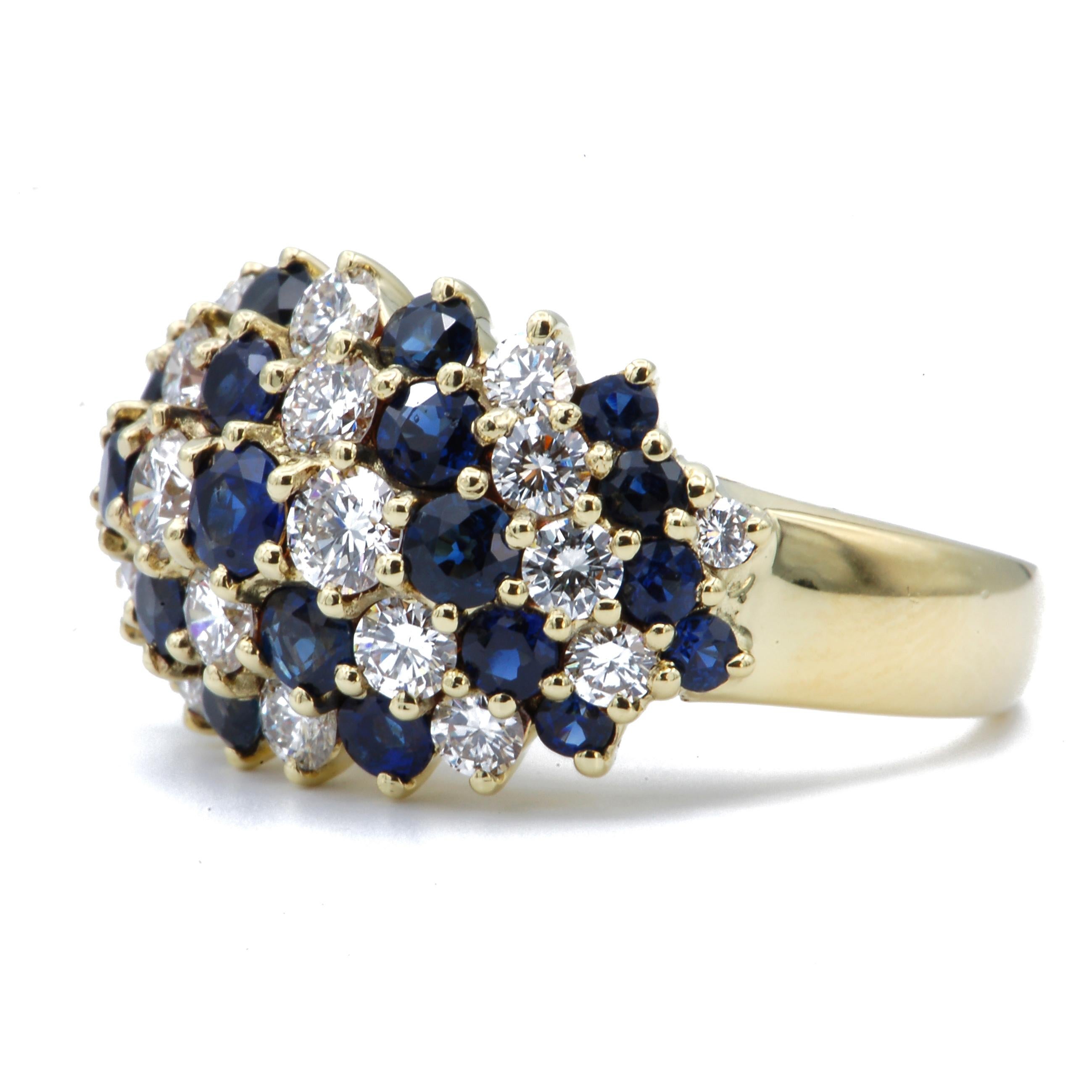 This magnificent diamond and sapphire ring is reminiscent of a vintage bombe cocktail ring.  Diagonal rows of sapphires and diamonds graduate in size to create the 