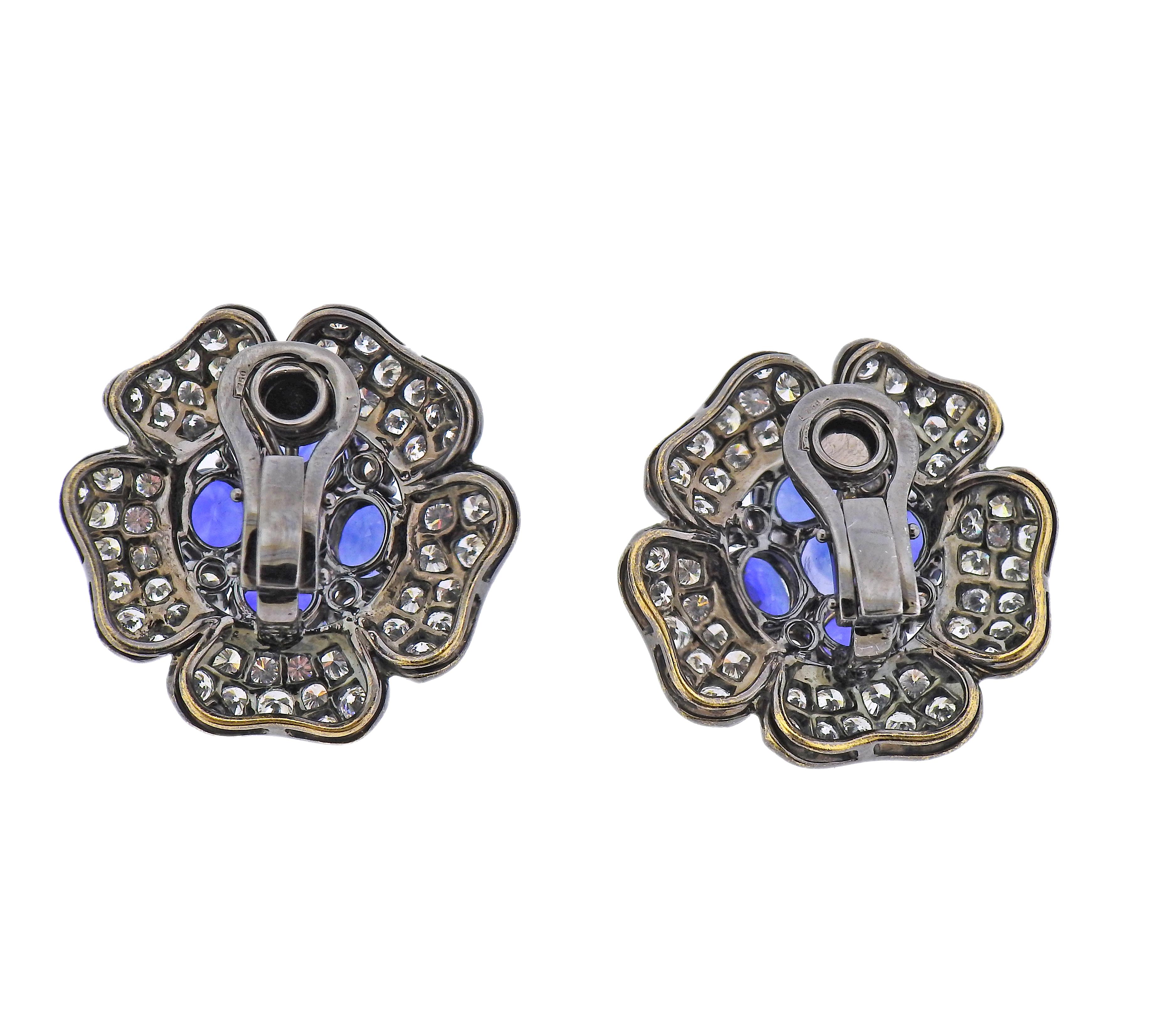 Pair of 18k blackened white gold flower earrings, set with blue sapphires and approx. 5.00ctw in diamonds. Earrings measure 29mm x 29mm. Marked: 750. Weight - 25.9 grams.