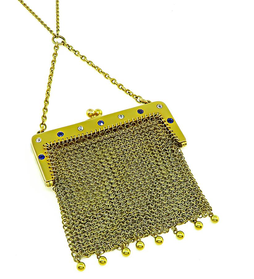 This is a gorgeous 14k yellow gold mesh purse necklace. The purse is accentuated by lovely round cut sapphire and diamond accents. The purse measure 74mm by 63mm. The necklace is stamped 14k and weighs 51.9 grams. The chain measures 33 inches in
