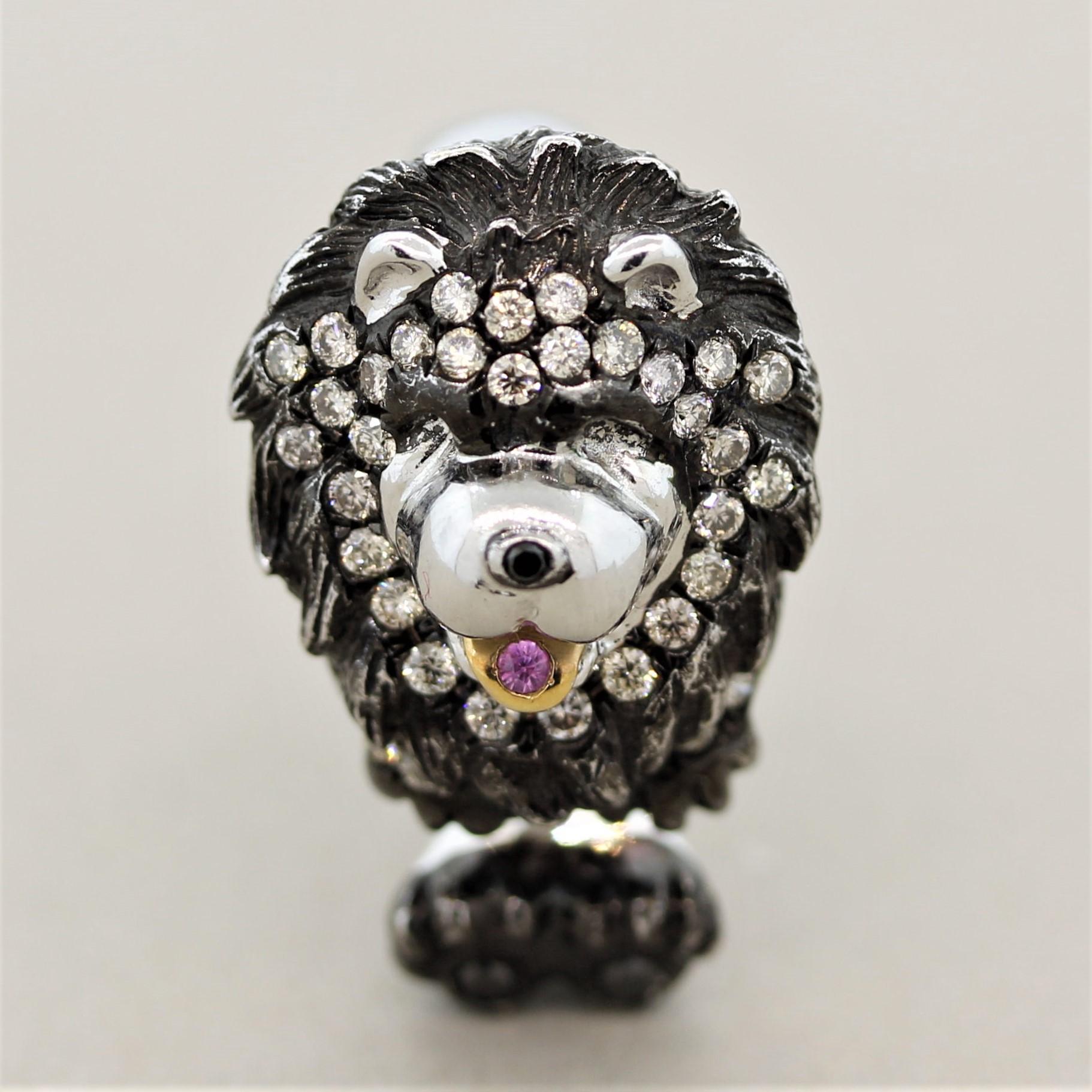 A sweet baby! This puppy dog features 0.52 carats of round brilliant cut diamonds set across its mane and paws. There is a single round shaped pink sapphire set in its mouth as its tongue. It is made in 18k white gold with a rhodium finish over the