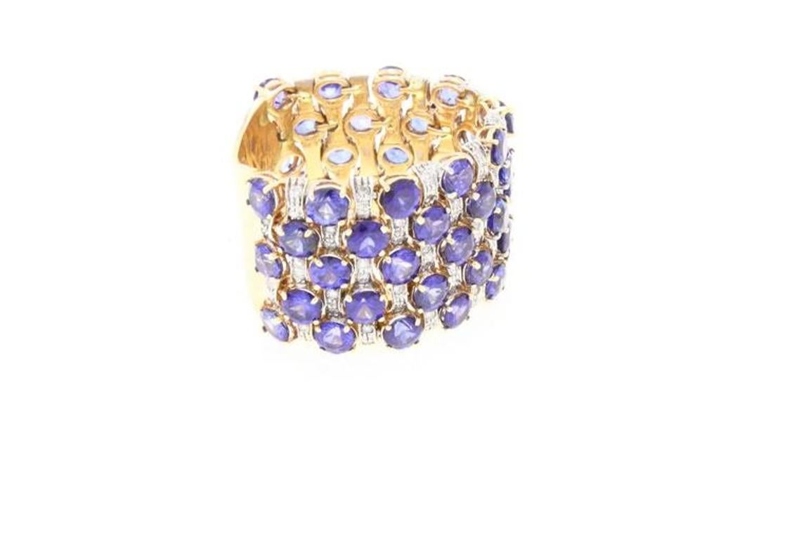 Shiny band ring in 14kt gold covered in diamonds and blue sapphires.
diamonds (1.65 kt) 
sapphires (10.08 kt)
tot weight 12.1gr 
The ring can be adapted to the required size
US size
width 0.63
diameter 0.98
cod.641578

For any enquires, please