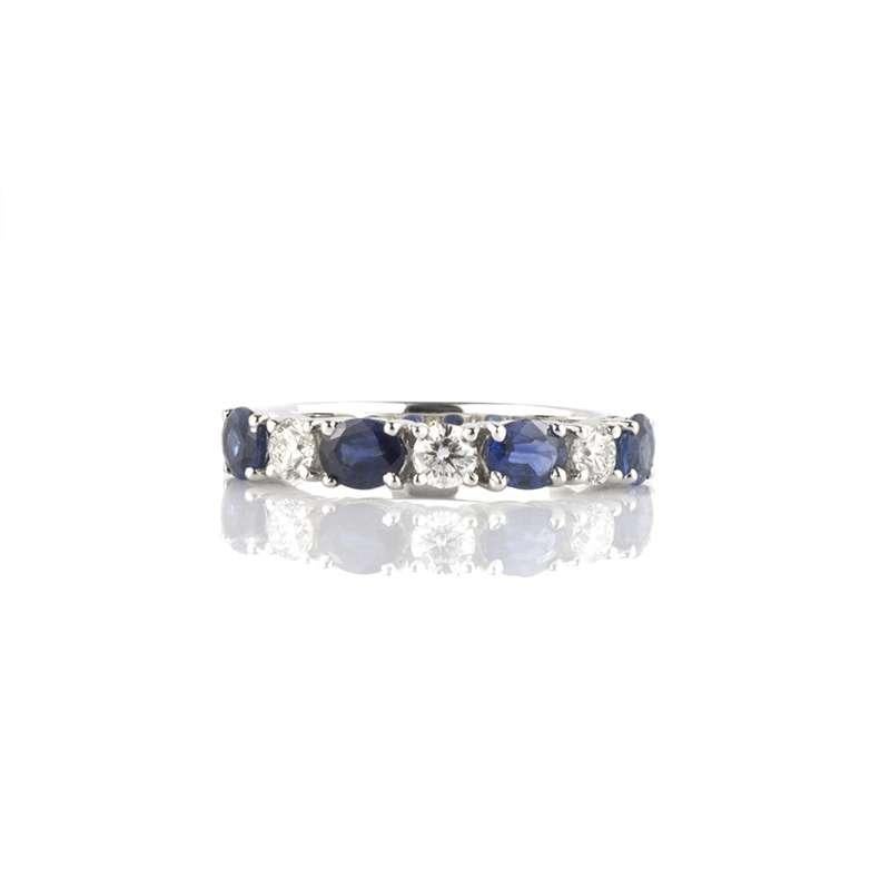 A beautiful 18k white gold diamond and sapphire half eternity ring. The ring is set with alternating round brilliant cut diamonds and oval cut sapphires all of which are in a four claw setting. The diamonds total 0.46ct, they are F-G in colour and