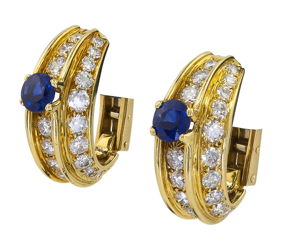 Diamond Sapphire Half Hoop Earrings in 18k Yellow Gold.

A versatile pair of classic half hoop earrings in yellow gold, embellished with white diamonds throughout and accented by two round brilliant blue sapphires.

Diamond weight approx. 3.21