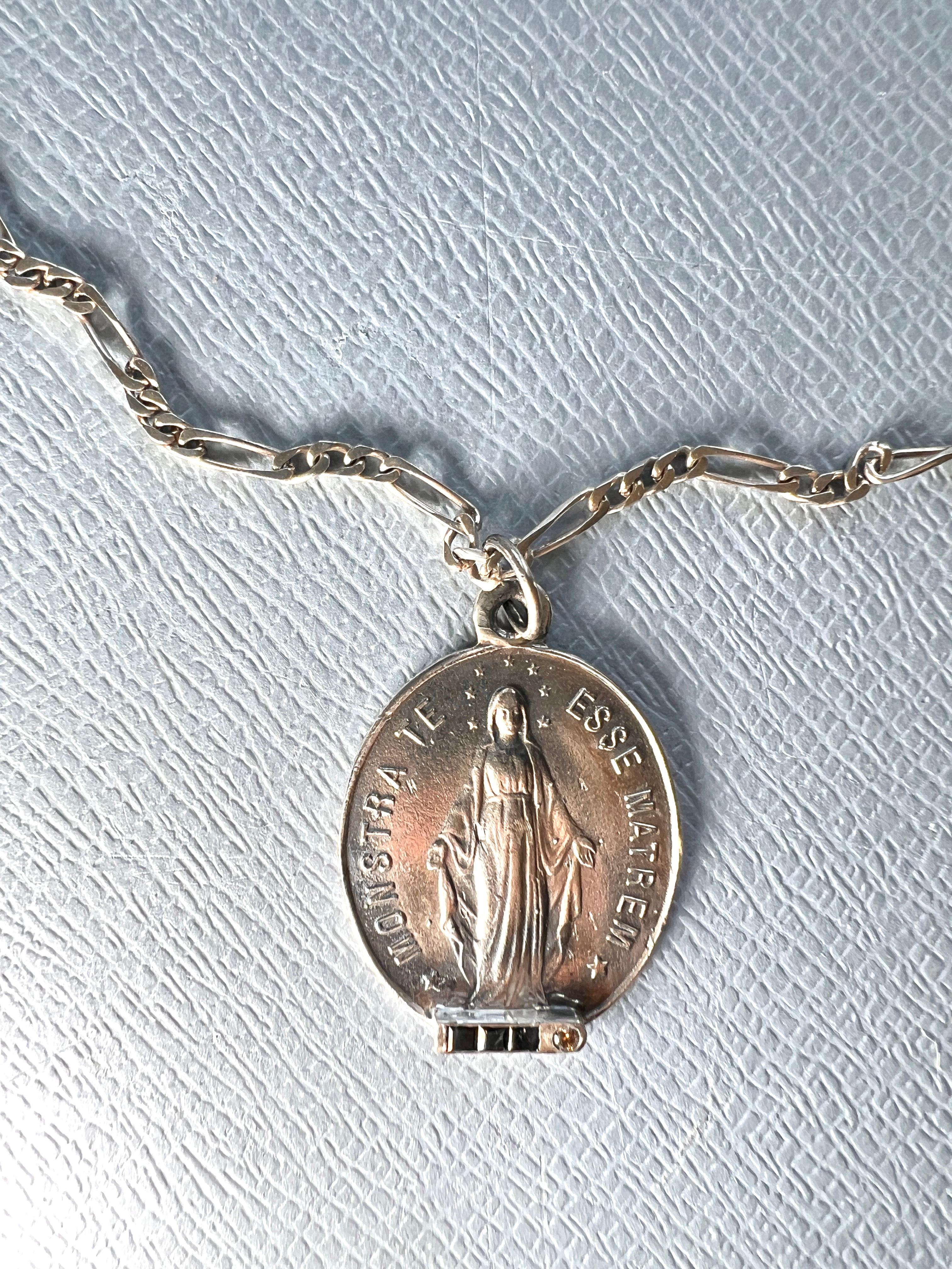 Diamond Sapphire Medal Virgin Mary Silver Vinatge Necklace

Length: 18 Inches

Monstra Te Esse Matrem – Show Thyself as Mother
Blue Sapphire & Diamond Religious Necklace

This sacred medal, inscribed with the timeless invocation “Monstra te esse