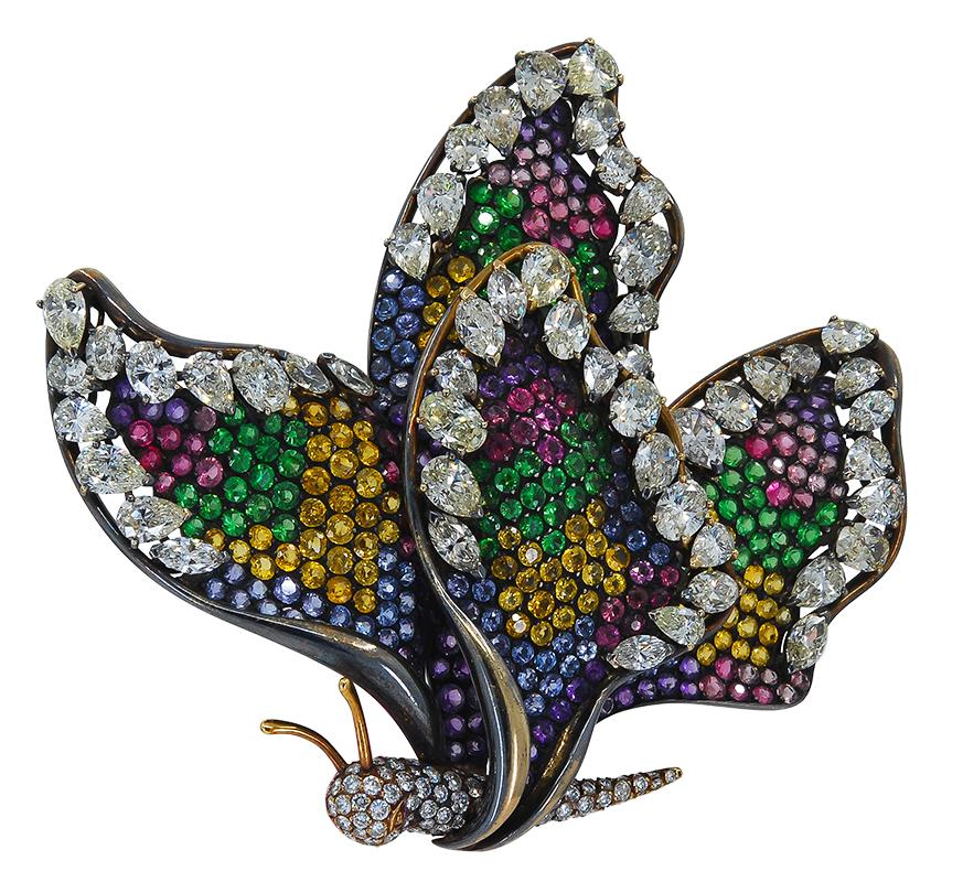 Diamond Sapphire Multicolor Pave Butterfly Brooch in 18k gold with black rhodium.

Blue, yellow, green, pink sapphire pavé – with white diamonds in oval, pear, marquise and round shapes.

Measures approx. 3 1/4″ in length, 3″ in width. French Assay