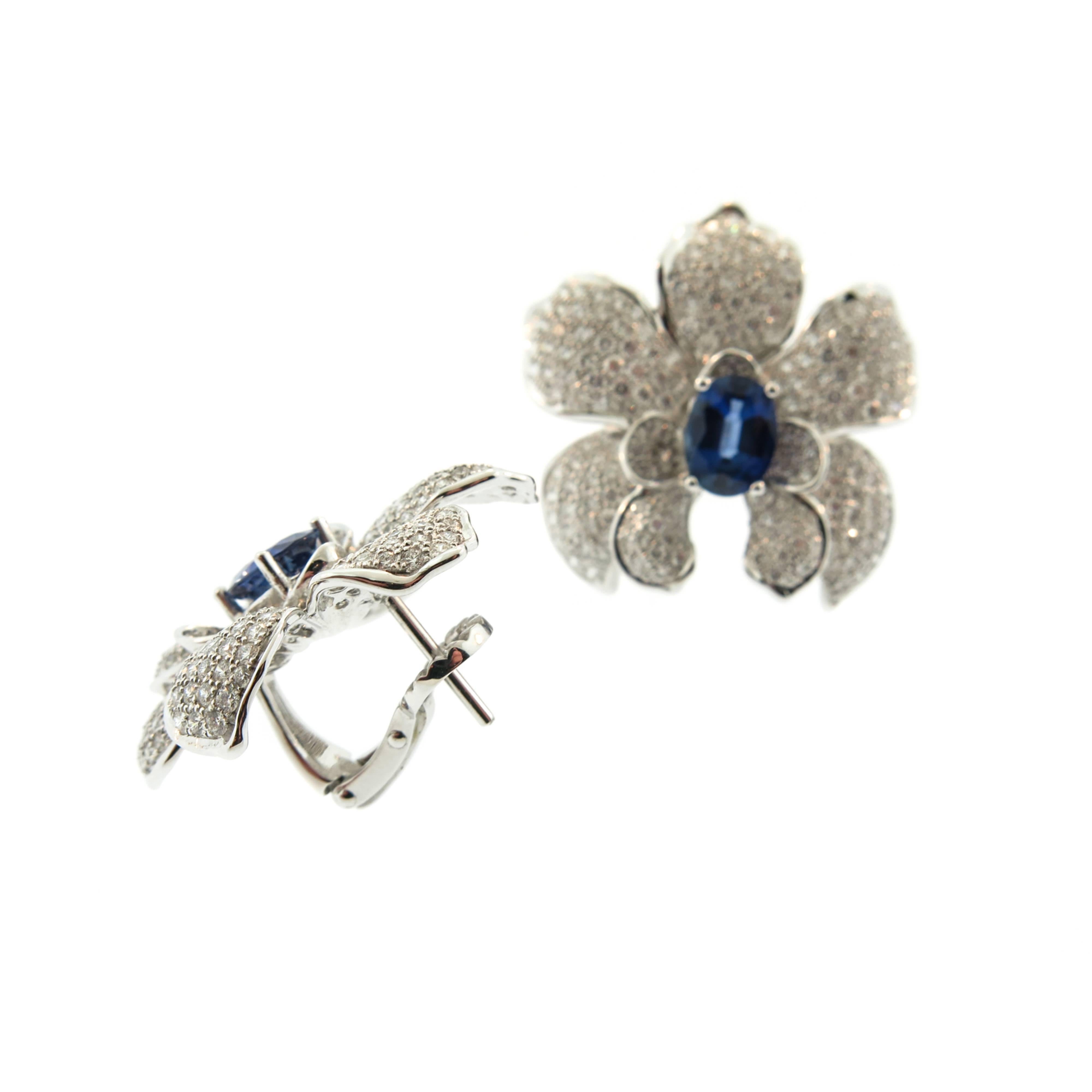 Extraordinary Orchid Earrings, this flower communicates sensuality, in its sophisticated finish, sculptural shape, and overflowing glamour. 
Created by Carrera y Carrera in 18k white gold with 408 white diamonds (3.70 ct.) and
 2.81 ct. sapphires