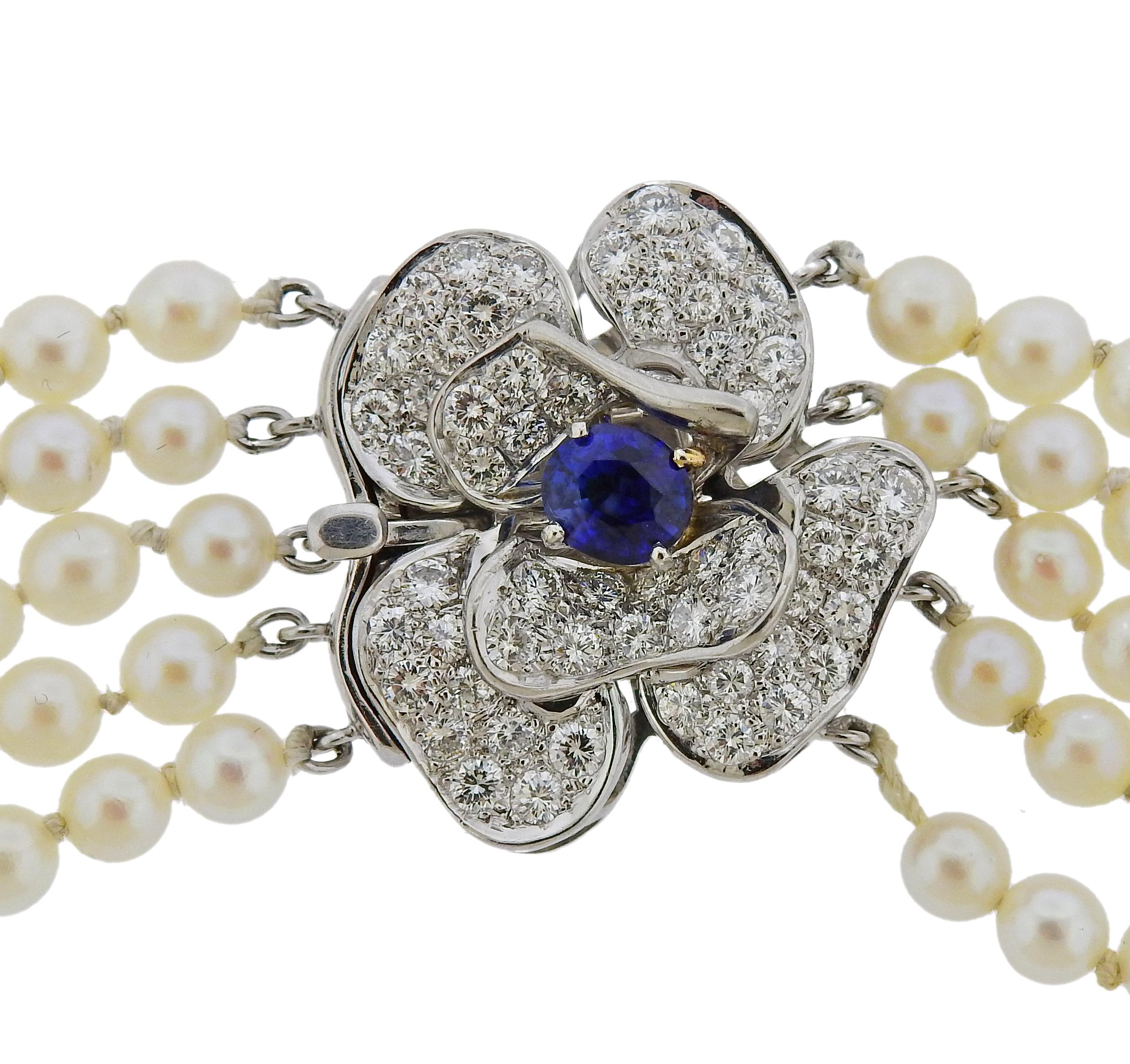 Multi strand pearl necklace, decorated with flower clasp, st with 6.4mm x 5.4mm oval sapphire, surrounded with approx. 1.50ctw in diamonds. Necklacce is 15