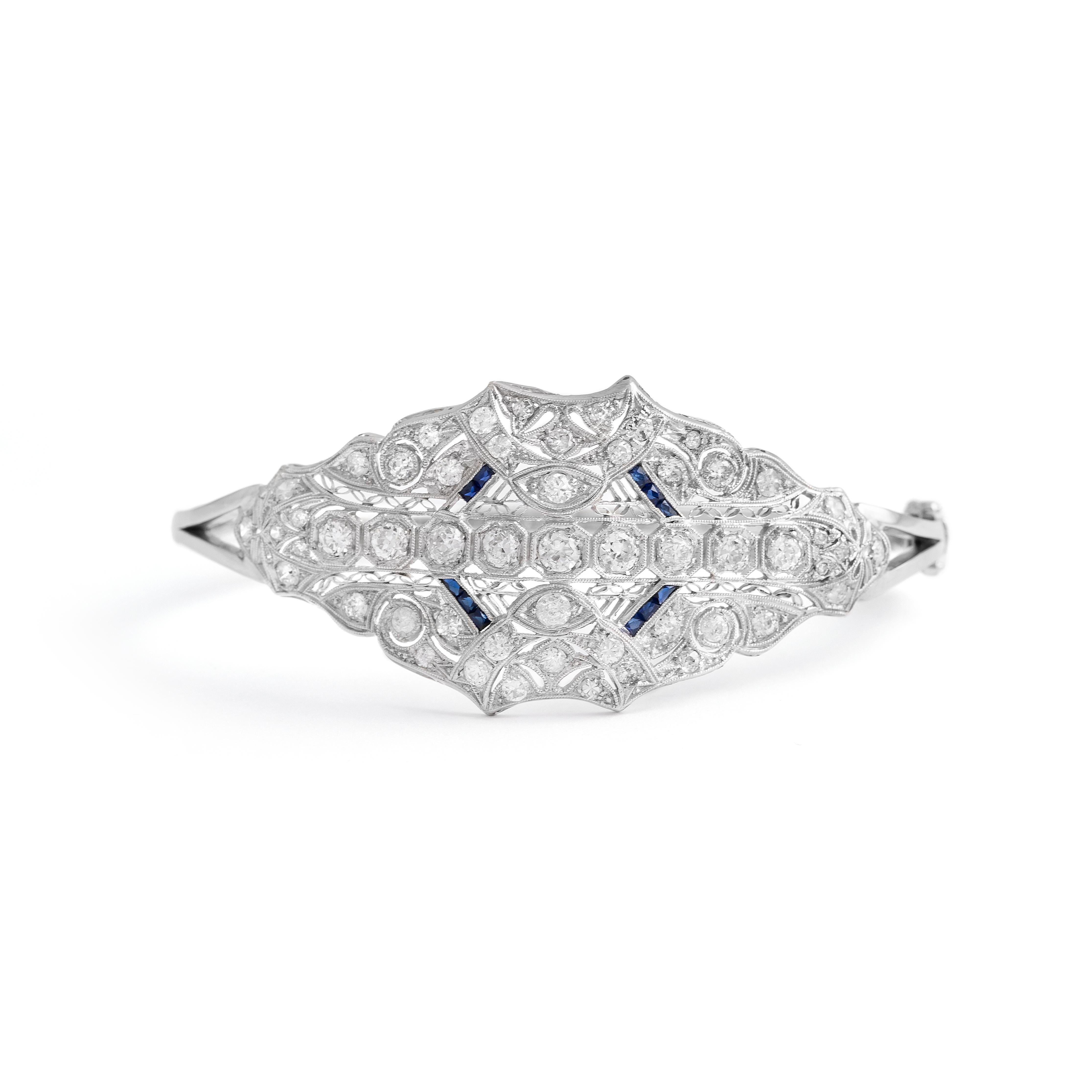 Old mine cut Diamond and calibrated Sapphire on Platinum and 14K White Gold Bangle.
Top part dimensions: 5.50 centimeters x 3.00 centimeters.
Wrist size: 18.00 centimeters.