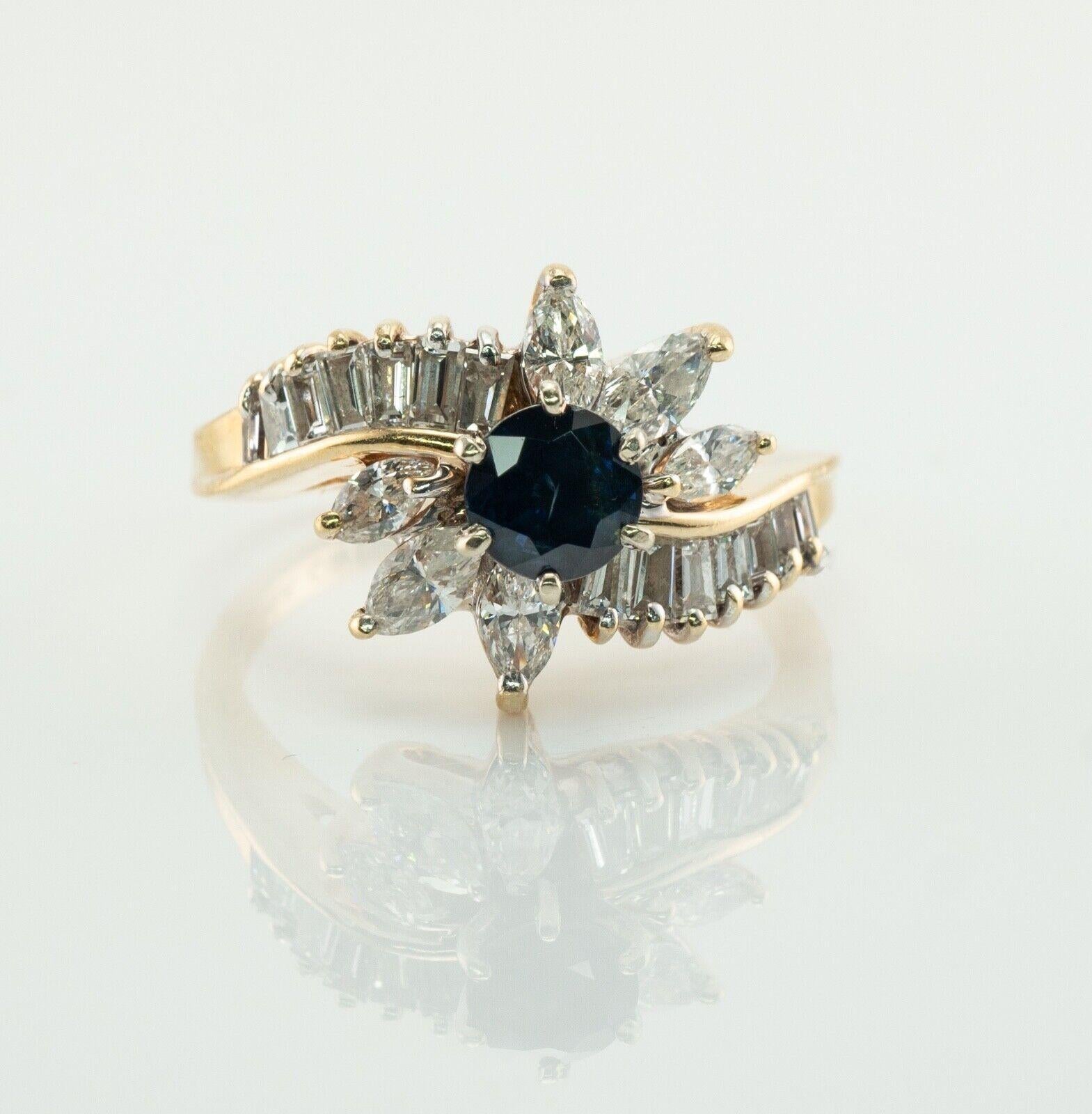 This estate ring is finely crafted in solid 14K Yellow gold and set with natural Earth mined Sapphires and Diamonds. The center round cut blue Sapphire measures 5mm (.65 carat). The center stone is surrounded with 6 marquise and 14 channel set white