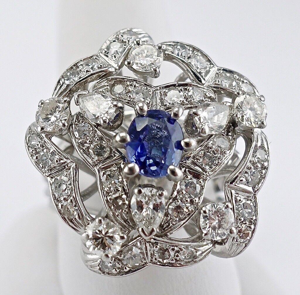 This beautiful vintage ring is finely crafted in solid 14K White gold (carefully tested and guaranteed), and set with genuine Earth mined Sapphire and diamonds. The center oval cut Sapphire measures 7mm x 5mm (1.00 carat), and this is a very clean