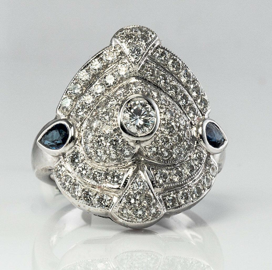 Diamond Sapphire Ring 14K White Gold Shield Cocktail

The ring is crafted in solid 14K White Gold and set with gorgeous diamonds and sapphires. 
The center bezel-set diamond is .20 carat. 
The face of the ring is encrusted with white and fiery