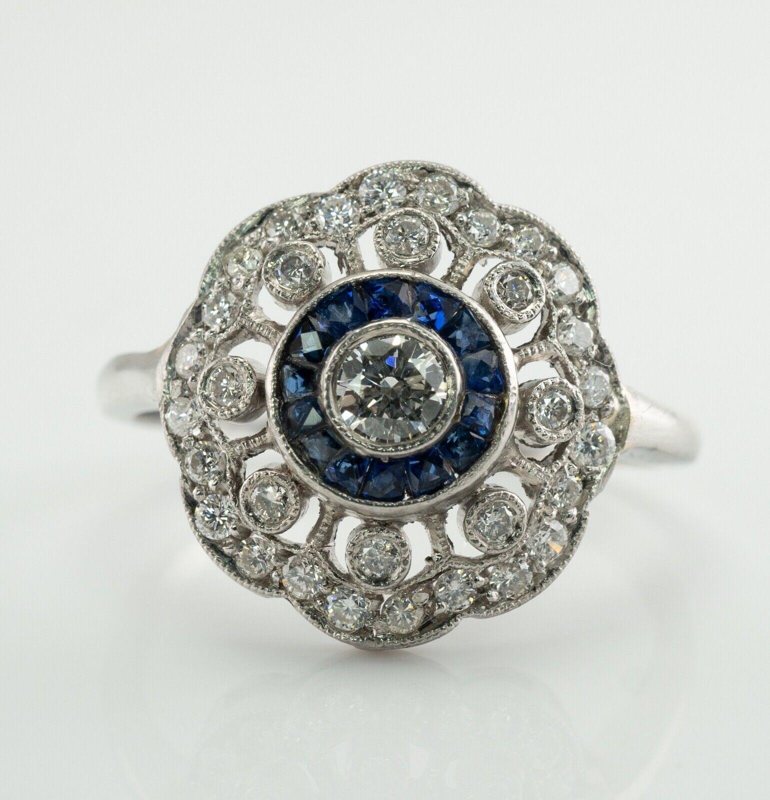 This pretty vintage ring is crafted in solid 14K White Gold (carefully tested and guaranteed).
The center round brilliant cut diamond is .20 carat.
8 surrounding diamonds total .24 carat.
And 24 small diamonds total .24 carat.
The total diamond
