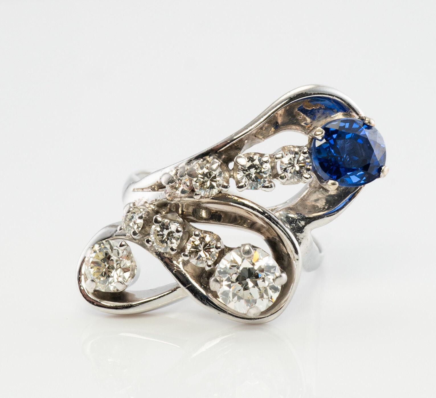 This dramatic vintage sapphire and diamond ring is crafted in solid 14K White gold (carefully tested and guaranteed). The oval cut high-quality Earth-mined Sapphire measures 6mm x 5mm (.80 carat), and this is a very clean and transparent gem of