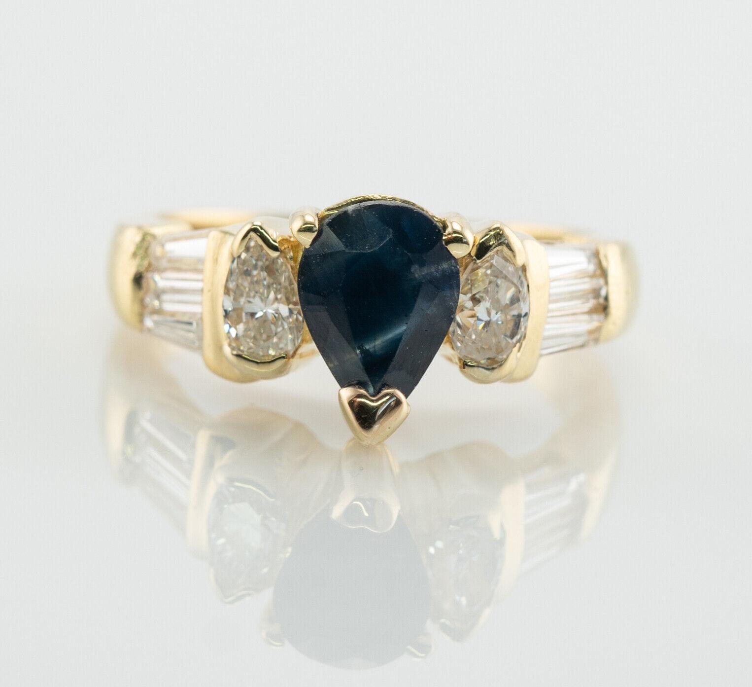 This lovely estate ring is finely crafted in solid 18K Yellow Gold and set with genuine Earth mined Sapphire and white and fiery diamonds. The center pear cut Sapphire is .75 carat (7mm x 5mm). Two pear cut diamonds total .50 carat and six tapered