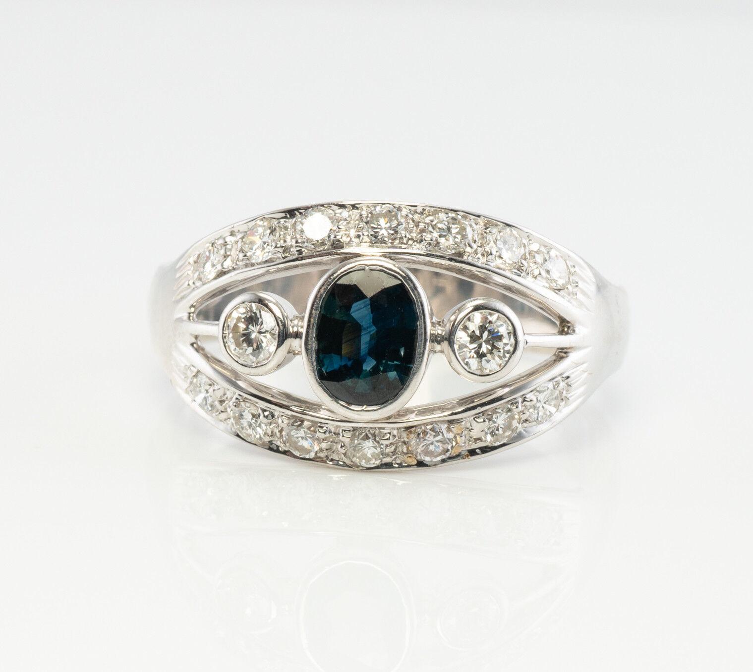 This gorgeous estate ring is finely crafted in solid 18K White gold and it is set with genuine Earth mined Sapphire and diamonds. The center bezel-set oval cut Sapphire measures 6mm x 4mm (.60 carat). This is a very clean gem of great intensity and