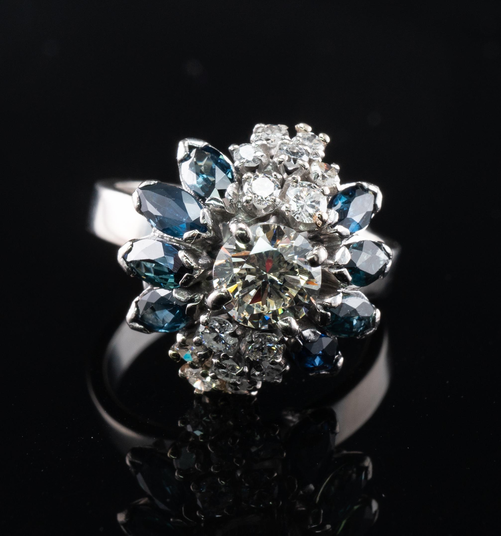 This beautiful vintage ring is finely crafted in solid 18K White gold.
The center round brilliant cut is .90 carat of VS1 clarity and IJ color. 
14 more diamonds total .35 carat of SI1 clarity and H color.
The total diamond weight for the ring is