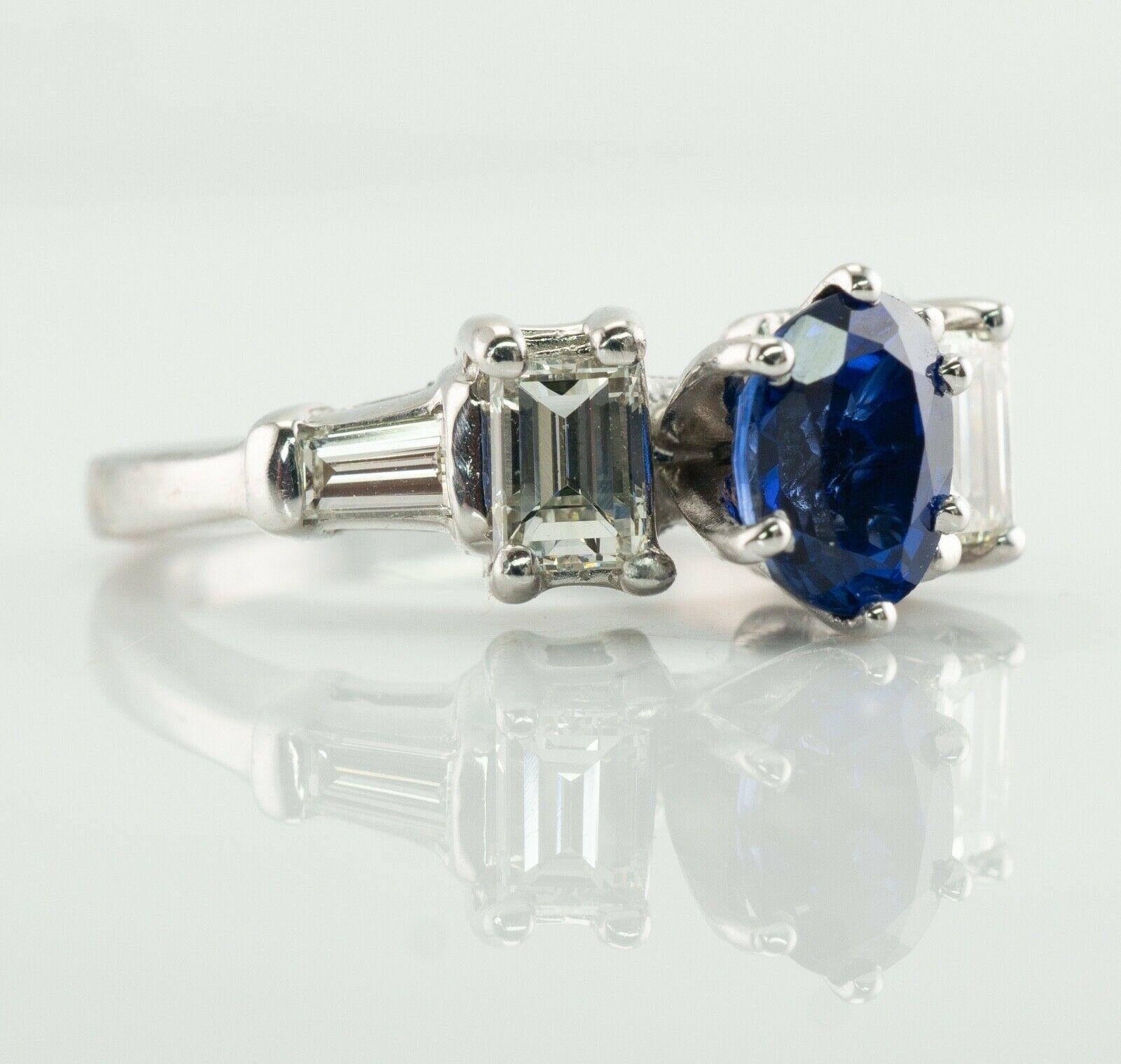 This gorgeous estate ring is finely crafted in luxurious Platinum and set with genuine Earth mined Sapphire and white and fiery diamonds. The center oval cut Sapphire is .60 carat (6mm x 4mm) and this is a very clean and transparent gem of great