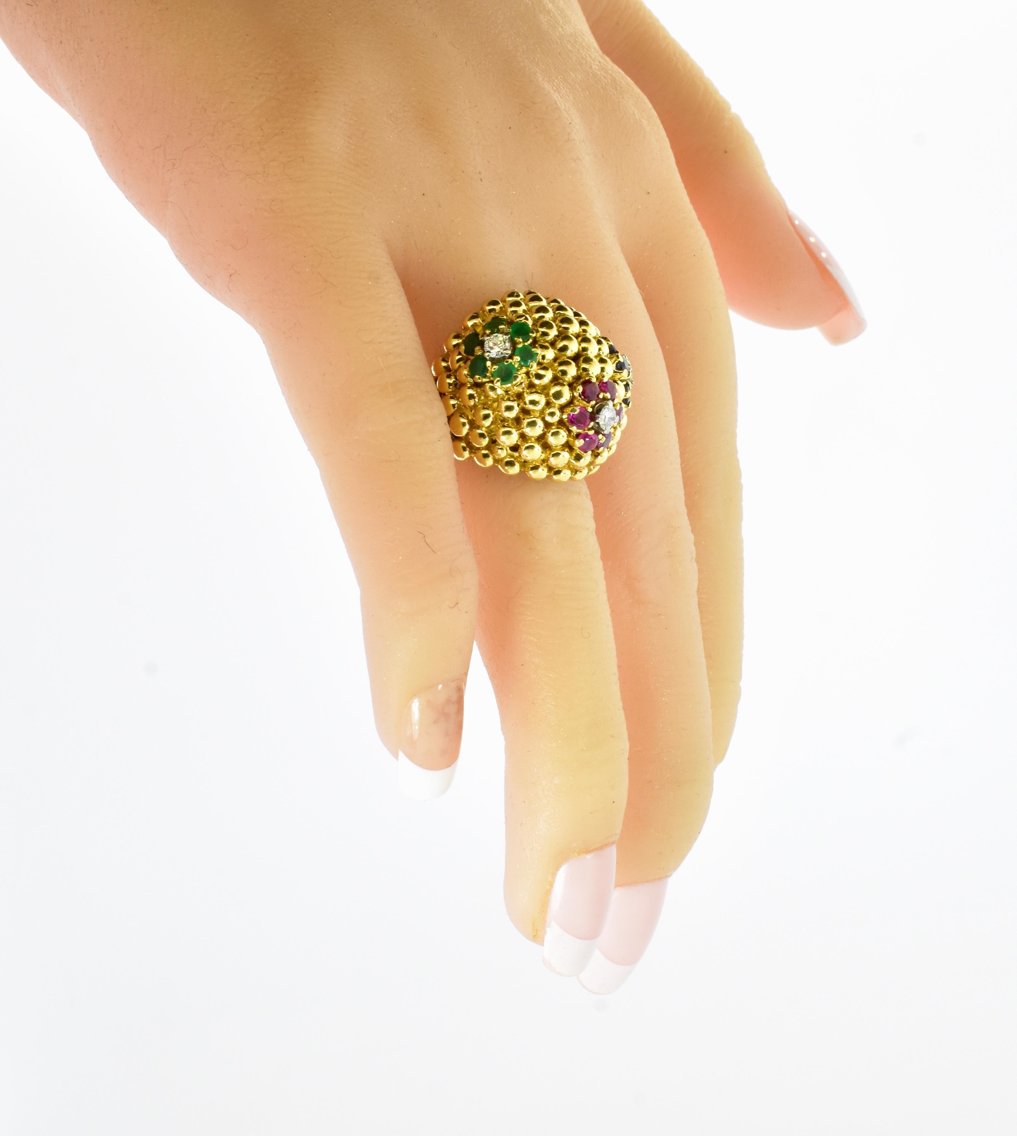 18K yellow gold, fine diamond, sapphire, ruby and emerald ring made in the early 1960's. This heavy and substantial ring in 18K, and marked on the interior of the shank weighs 20.7 grams. The gold bead work is done well and shows off the flower