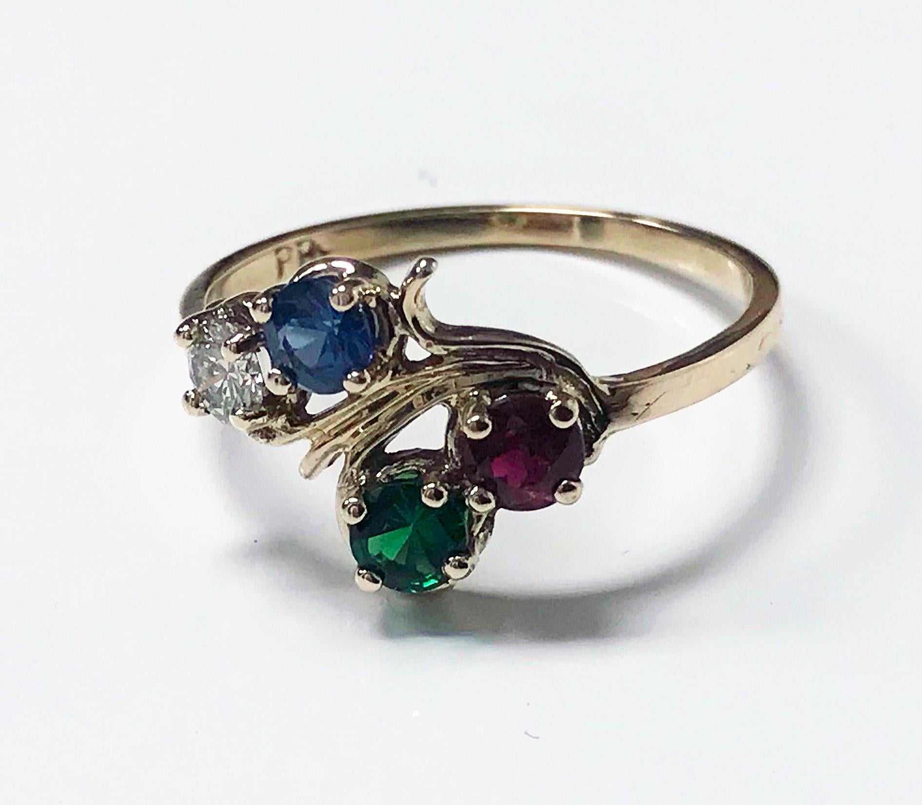 Diamond, Sapphire, Ruby and Tsavorite Ring. Diamond 0.15 ct, VS clarity, H colour, Sapphire medium light moderately strong blue, 0.20ct, Ruby, medium moderately strong Red, 0.,18 ct, fine green tsavorite, 0.17 ct The mount of twist twig design,