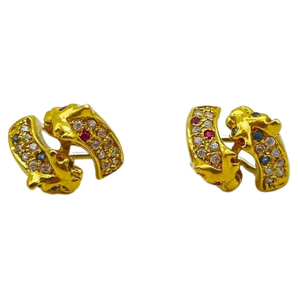 Behold the breathtaking beauty of these exquisite diamond earrings, crafted in a stunning and lustrous 18-karat yellow gold alloy. This mesmerizing pair of earrings features a captivating design with two majestic panthers facing each other, locked