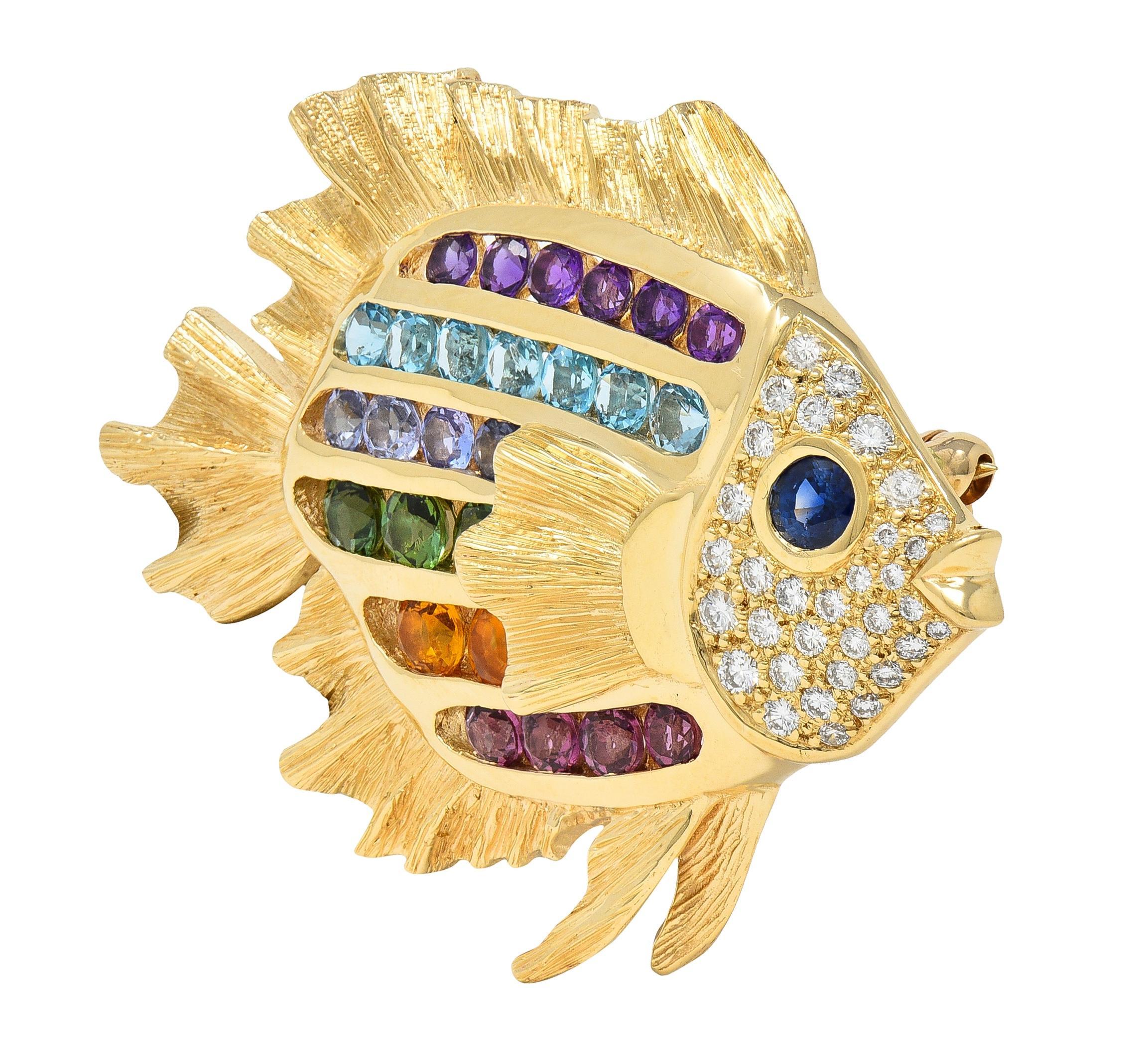 Designed as a stylized tropical fish with dimensional fins engraved with linear texture
Featuring stripes comprised of channel set round cut multi-gems
Transparent blue, purple, violet, orange, green and pink
Including topaz, amethyst, citrine, and
