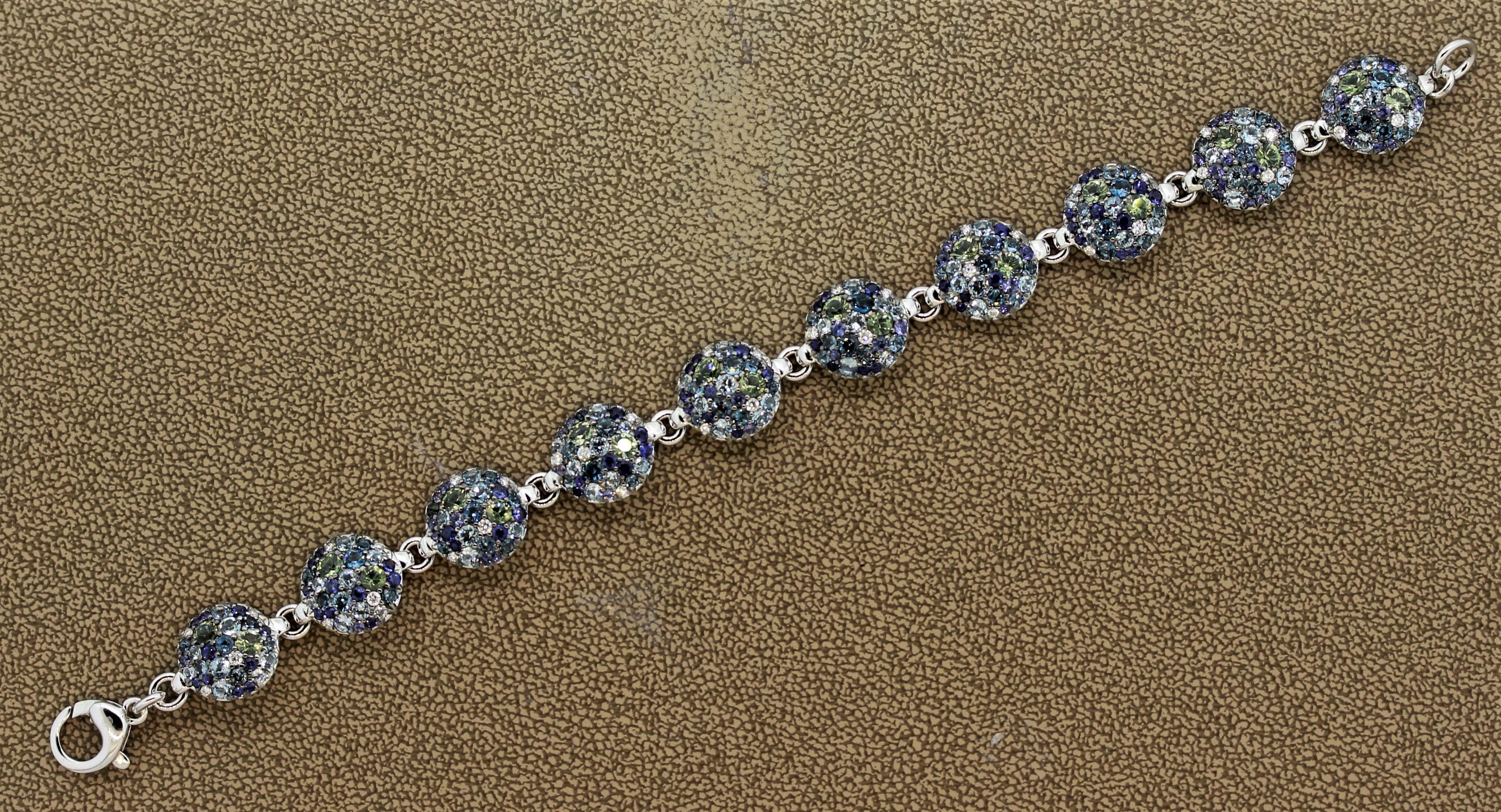 Gems on gems on gems! This lovely colorful bracelet features a total of 11.44 carats of fine gems which include round brilliant cut diamonds, green tourmalines, soft blue aquamarines and swiss blue topaz. Each gem has its own unique color along with