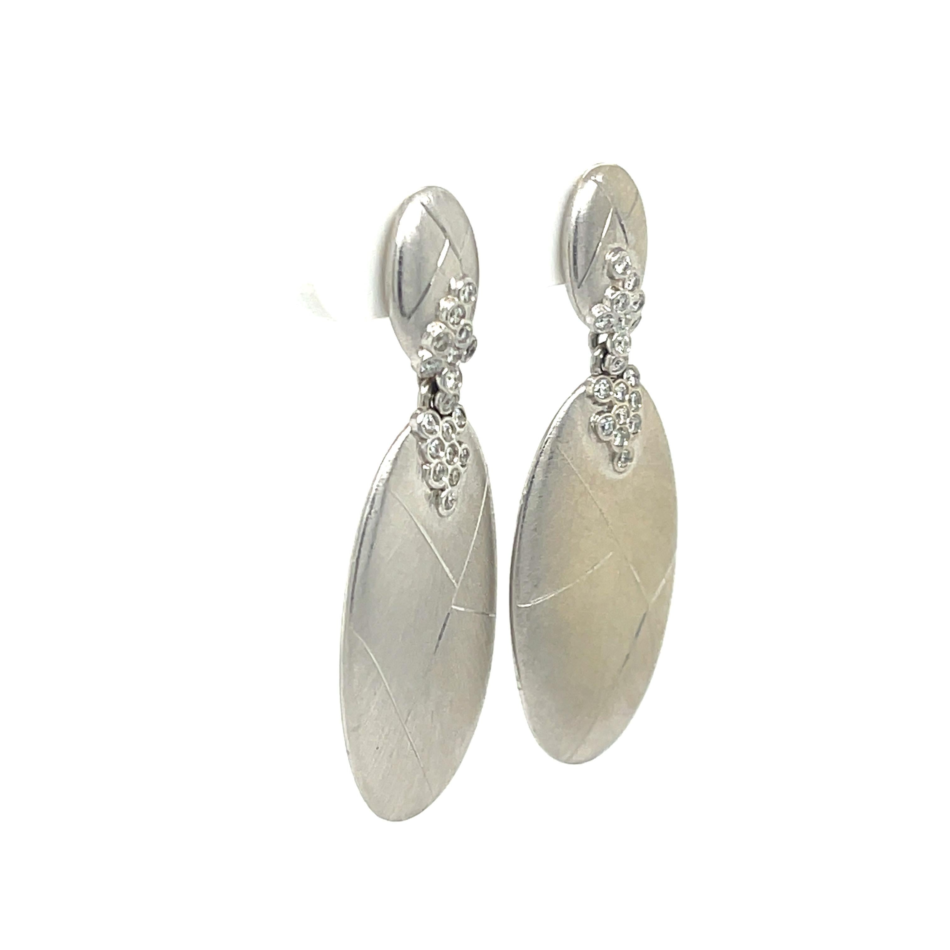 Satin Oval Dangle Earrings in 18K White Gold, The earrings feature 36 brilliant round cut diamonds.
1.75