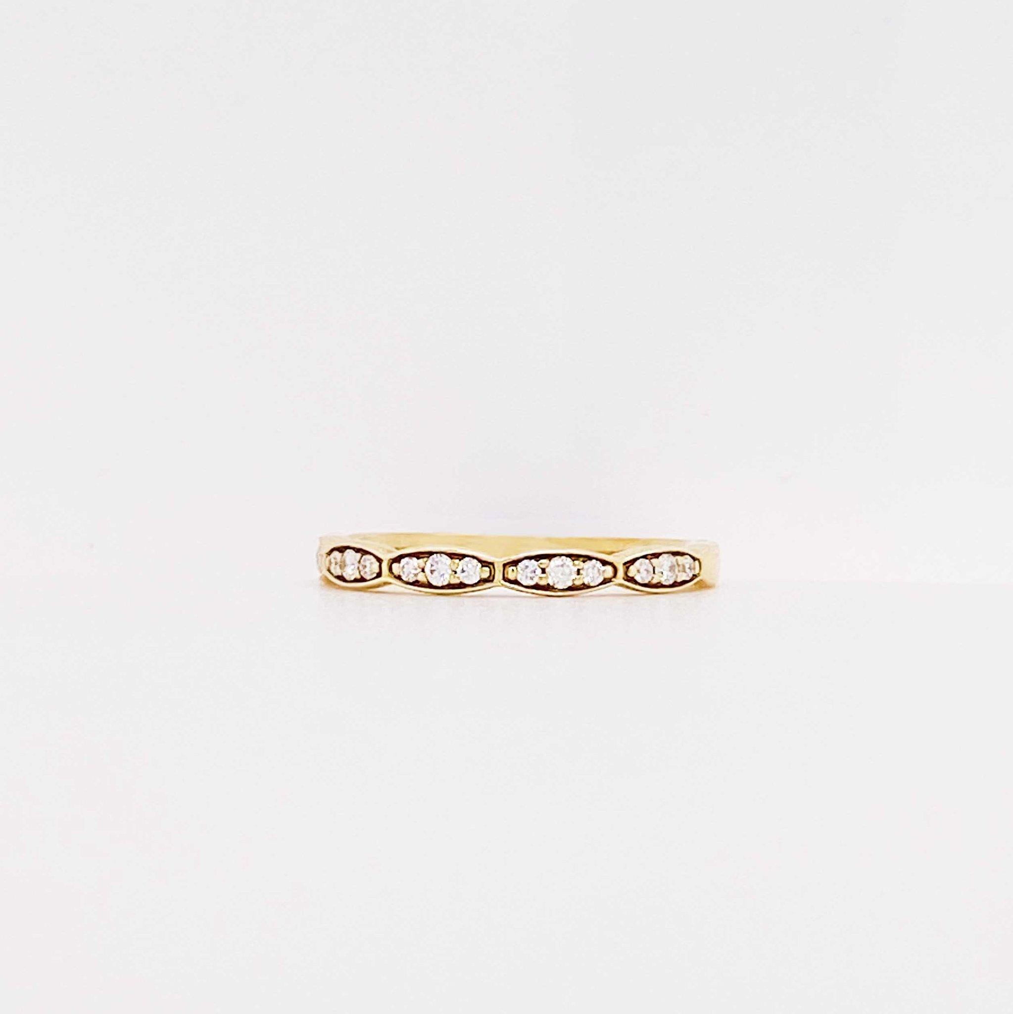 The diamond scallop band is a modern design with genuine round brilliant diamonds set in 14k yellow gold. This diamond band has a scalloped profile design that resembles Tacori. The diamond ring is versatile and can be paired with almost any ring.