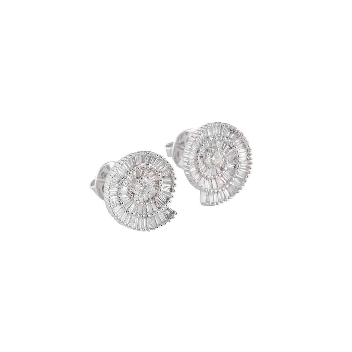 A stylish pair of 18k white gold diamond earrings. The earrings have baguette cut diamonds set in a spiral meeting a round brilliant cut diamond totalling to a weight of 2.35ct, colour H and clarity VS. The diamonds are set in a prong setting