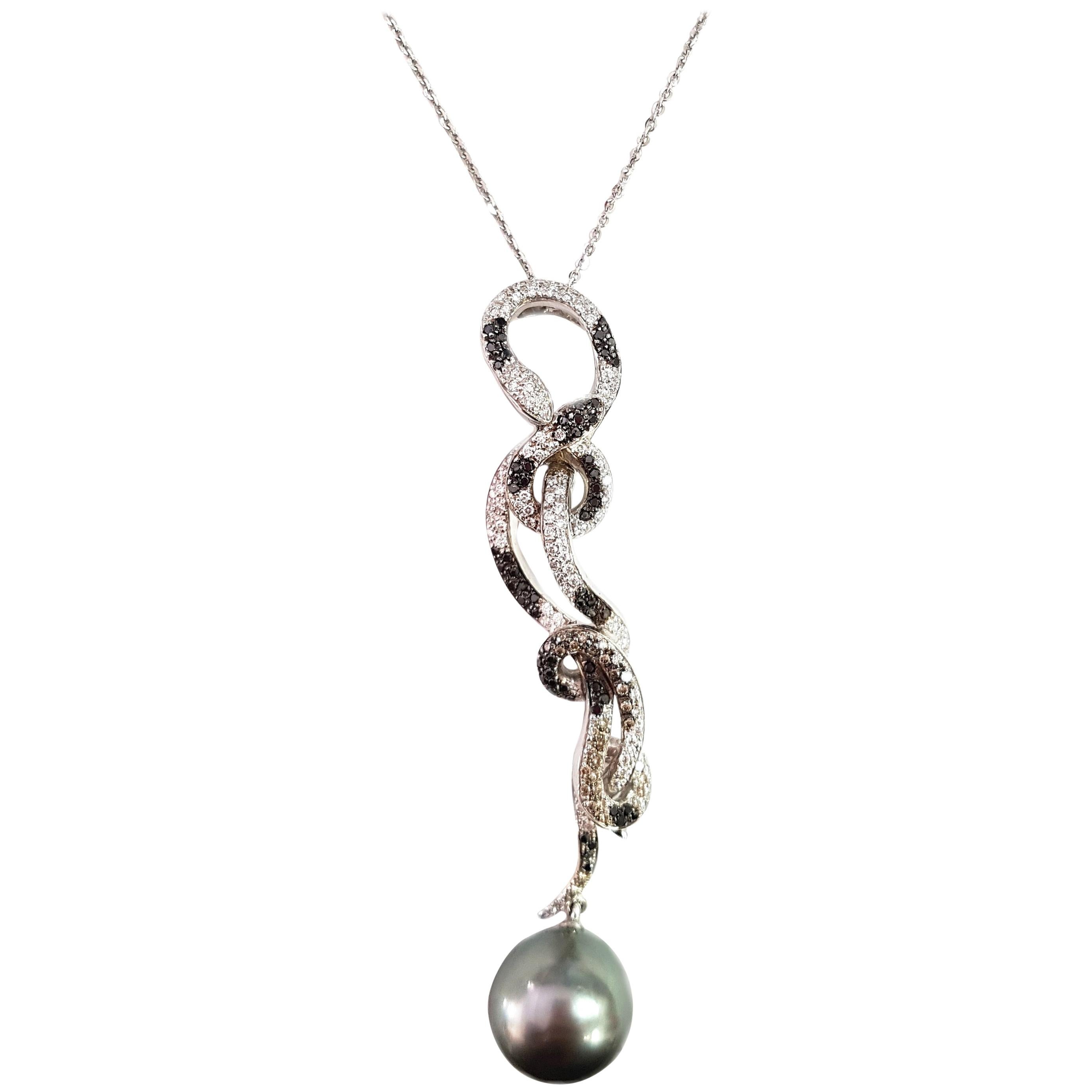 An exquisite pair of black and white serpents, set with a total of 1.06 carats of black and white diamonds, writhe together – below the serpents hangs an 18.20-carat grey Tahitian pearl. Both the necklace and pendant are crafted from 18-karat white