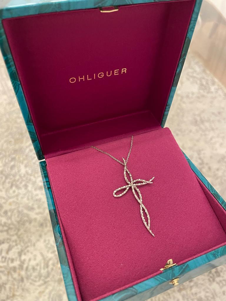 Custom OHLIGUER Croc tail Cross pendant in 18ct white gold

With 18ct gold extender chain

Croc skin filigree detail

Set with 45 diamonds GSI = 0.25ct total diamond weight

We can customise this jewel in your choice in white/ rose/ yellow gold 18k 