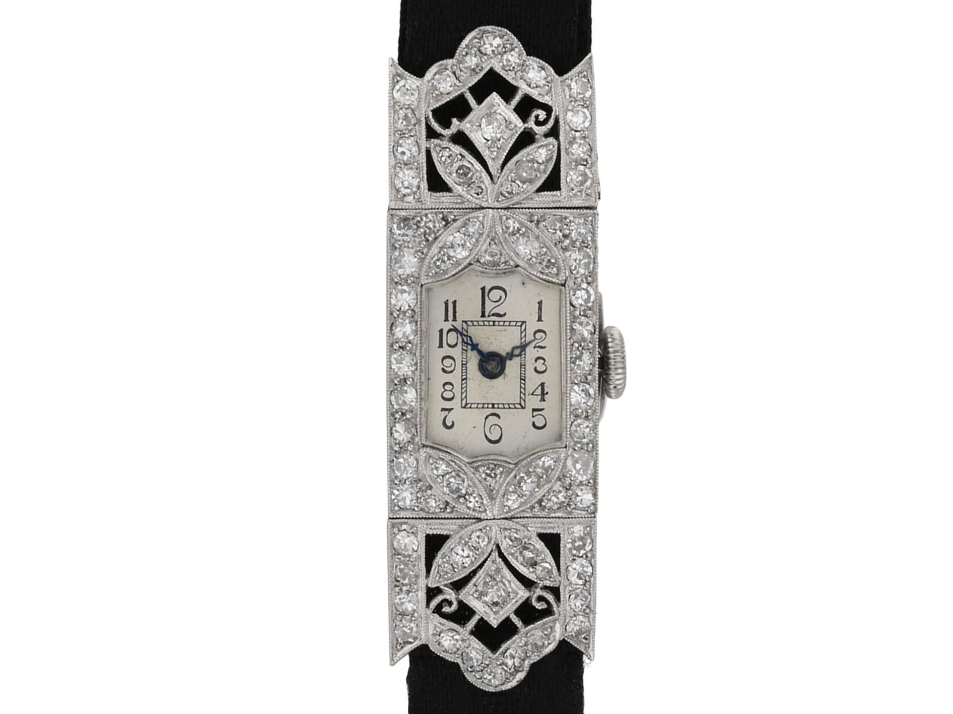 Art Deco diamond set dress watch. Set centrally with an Arabic, white dial with blue steel hands,further decorated with seventy six pavé set old cut diamonds in grain settings with a combined approximate weight of 1.50 carats, to a monochrome dress