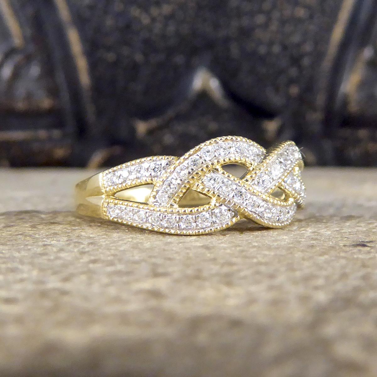 This gorgeous plait ring features 49 Modern Brilliant Cut Diamonds all of equal size set in a channel with detailing formed to look like a Diamond set plait. The Diamonds are clear and bright with the plait weave spreading the full head of the ring