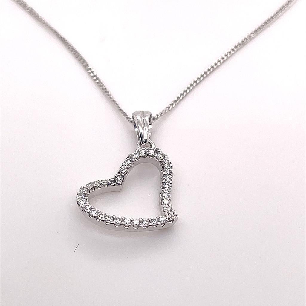 A diamond set open heart pendant in 18 karat white gold.

Simple and elegant this contemporary pendant is designed as a stylized open heart set with round brilliant cut diamonds of 0.40 carat in total, assessed as G-H colour, VS1 clarity.

This