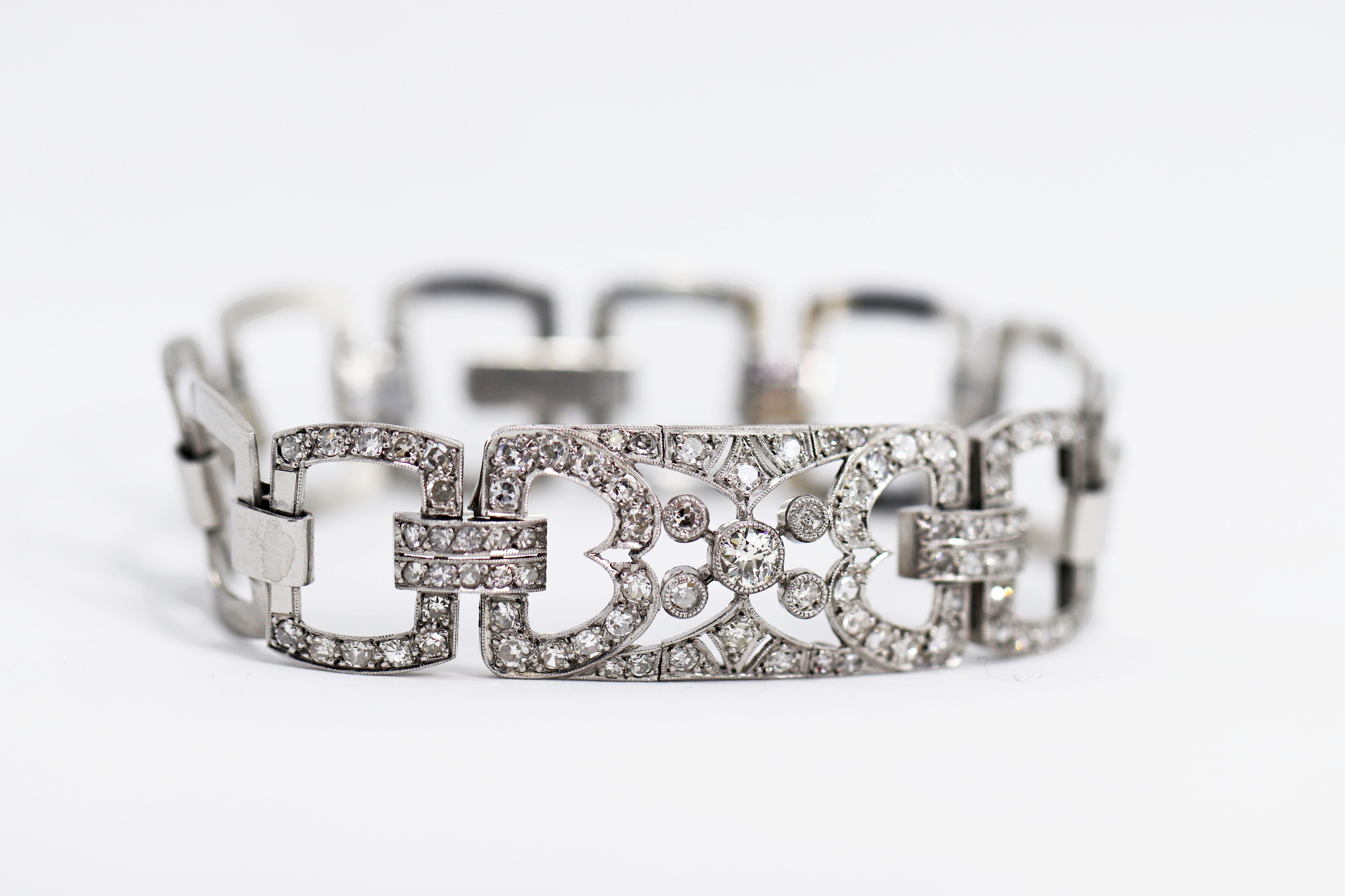Beautiful handmade open work platinum bracelet, grain set with 87 old cut diamonds weighing a total approximate weight of 4.20 carats. The bracelet is made with squared flat links connected loosely together to add flexibility and finished with a