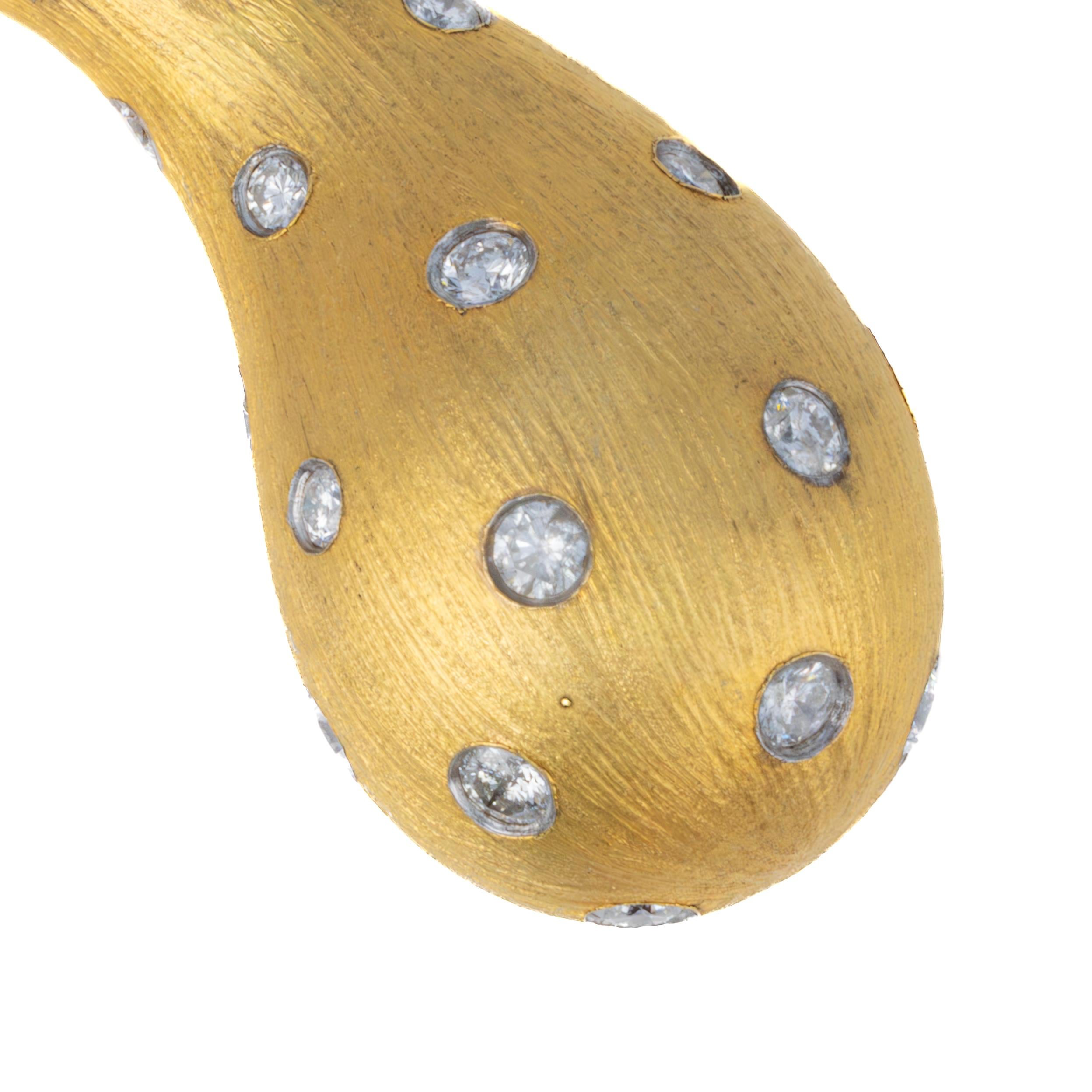 Diamond-Set Teardrop Earrings

Description:
These striking teardrop-shaped earrings are crafted in rich 18 karat yellow gold and feature a playful yet elegant design with scattered bezel-set round brilliant diamonds throughout. The matte brushed